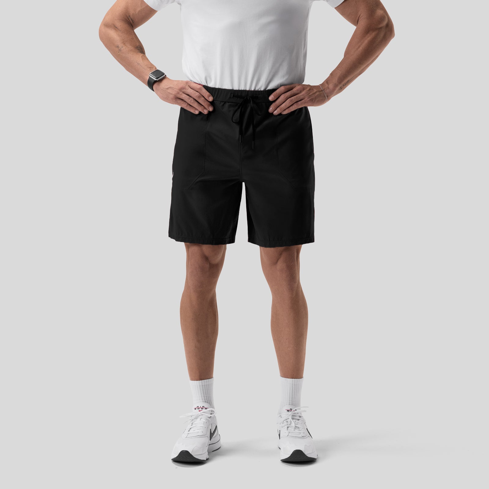 Black Aerotex™ 8" Training Short on model wearing white tee and white sneakers, front view