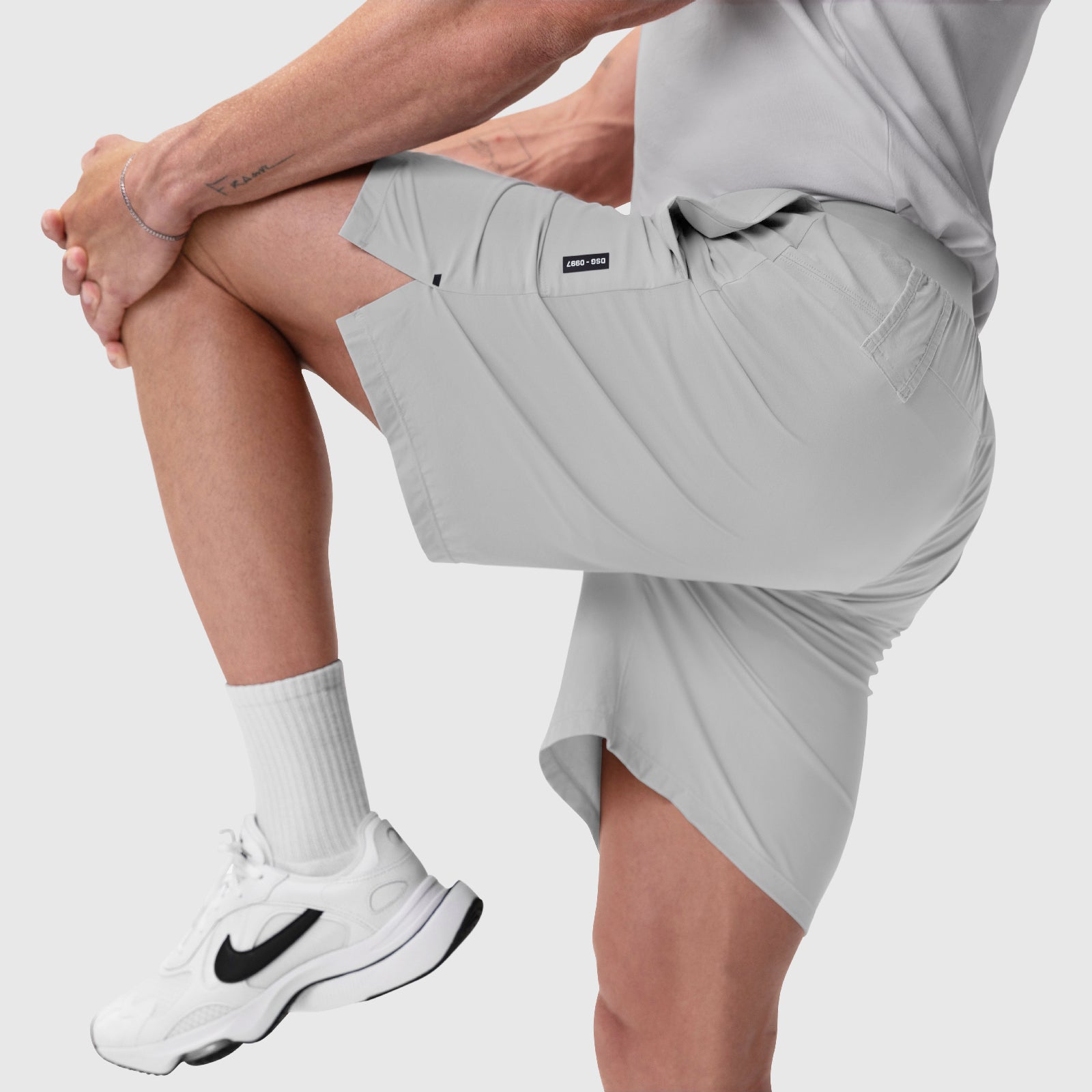 Aerotex™ 8" Training Short in Slate Grey, worn by model lifting leg, front view