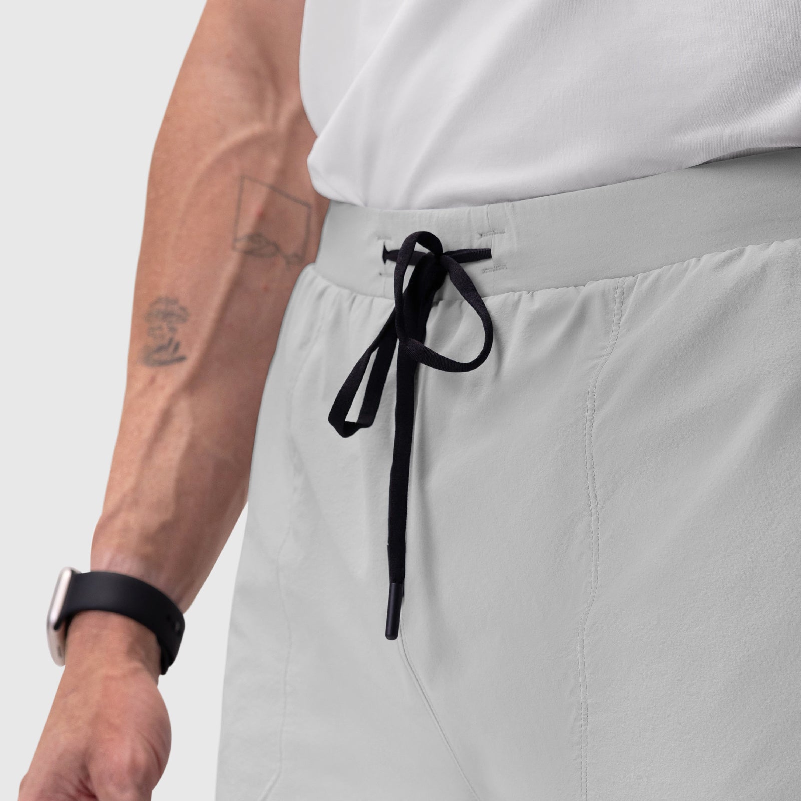 Aerotex Training Short in white, worn with drawstring detail and wrist accessory visible