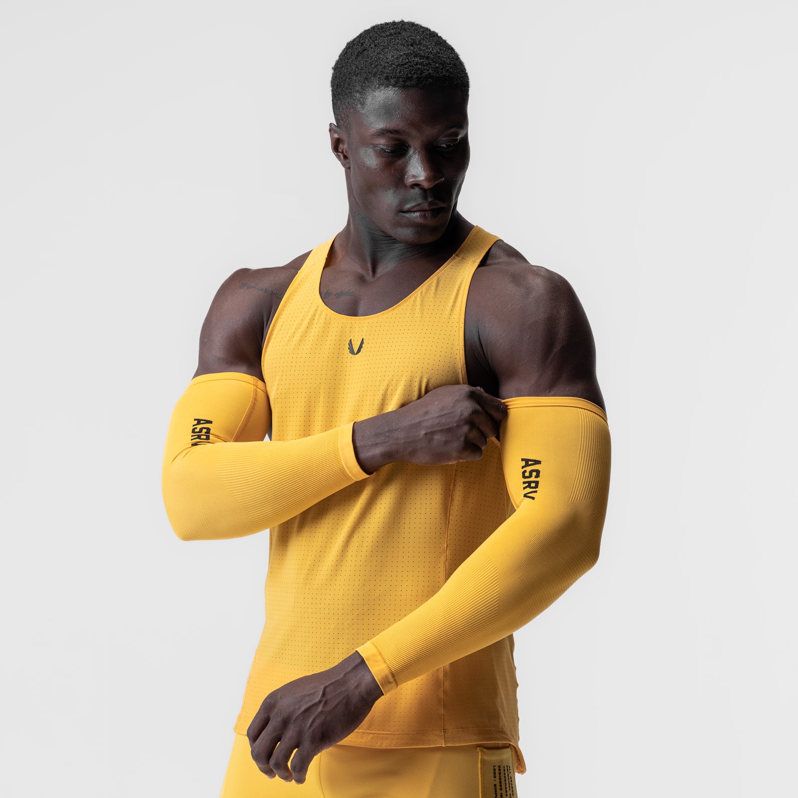 Body-Mapped Arm Sleeve in amber, worn on model with matching tank top
