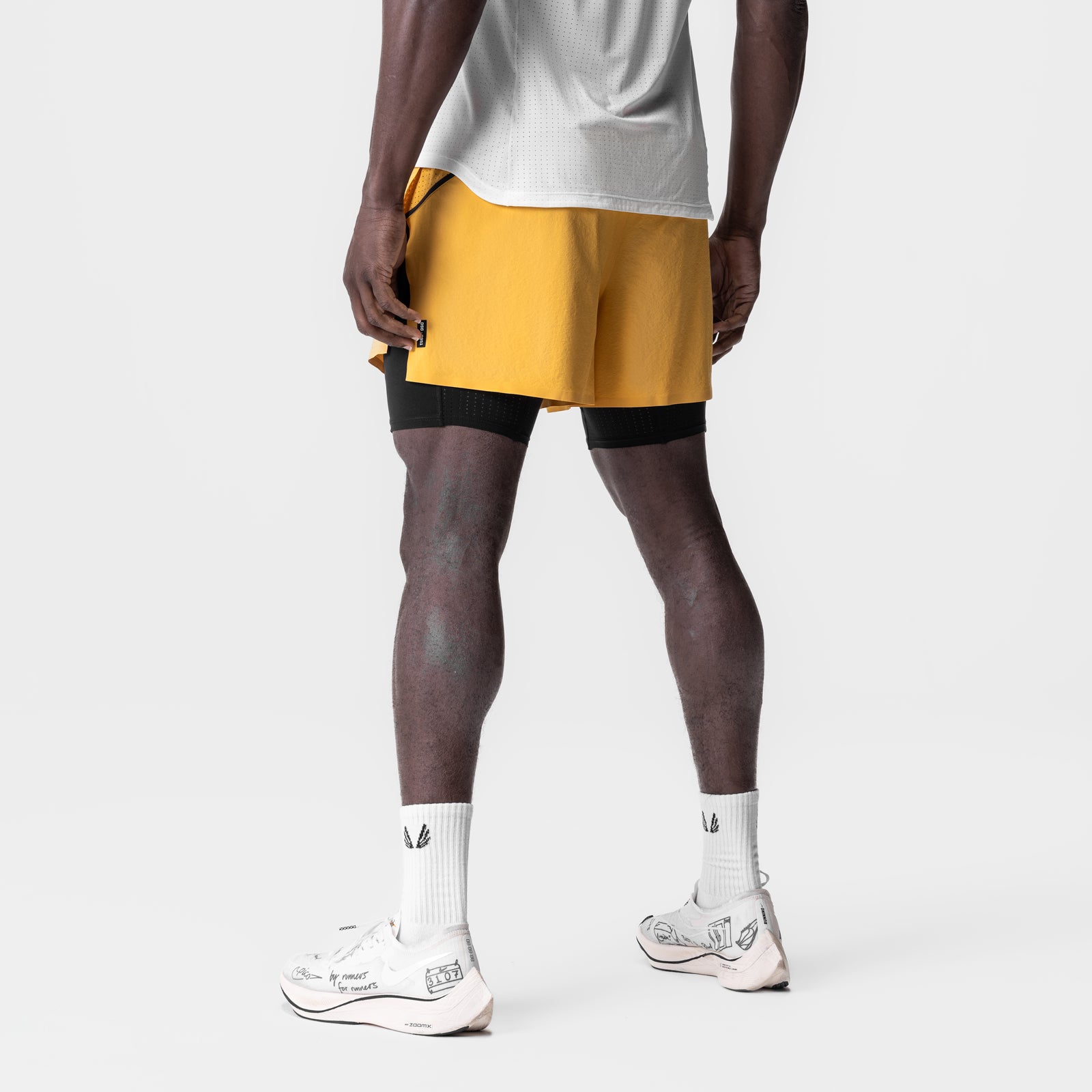 Aerotex 4" High Split Liner Short in amber with black liner shorts, worn with white socks and sneakers