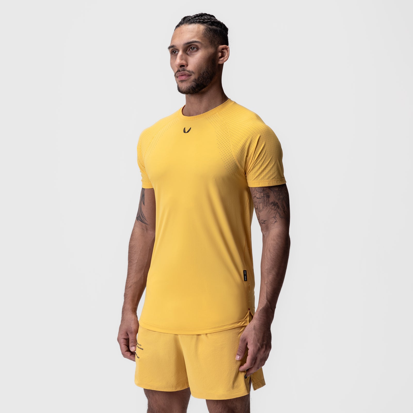 Laser-Vent Established Tee in amber yellow worn by model, front view