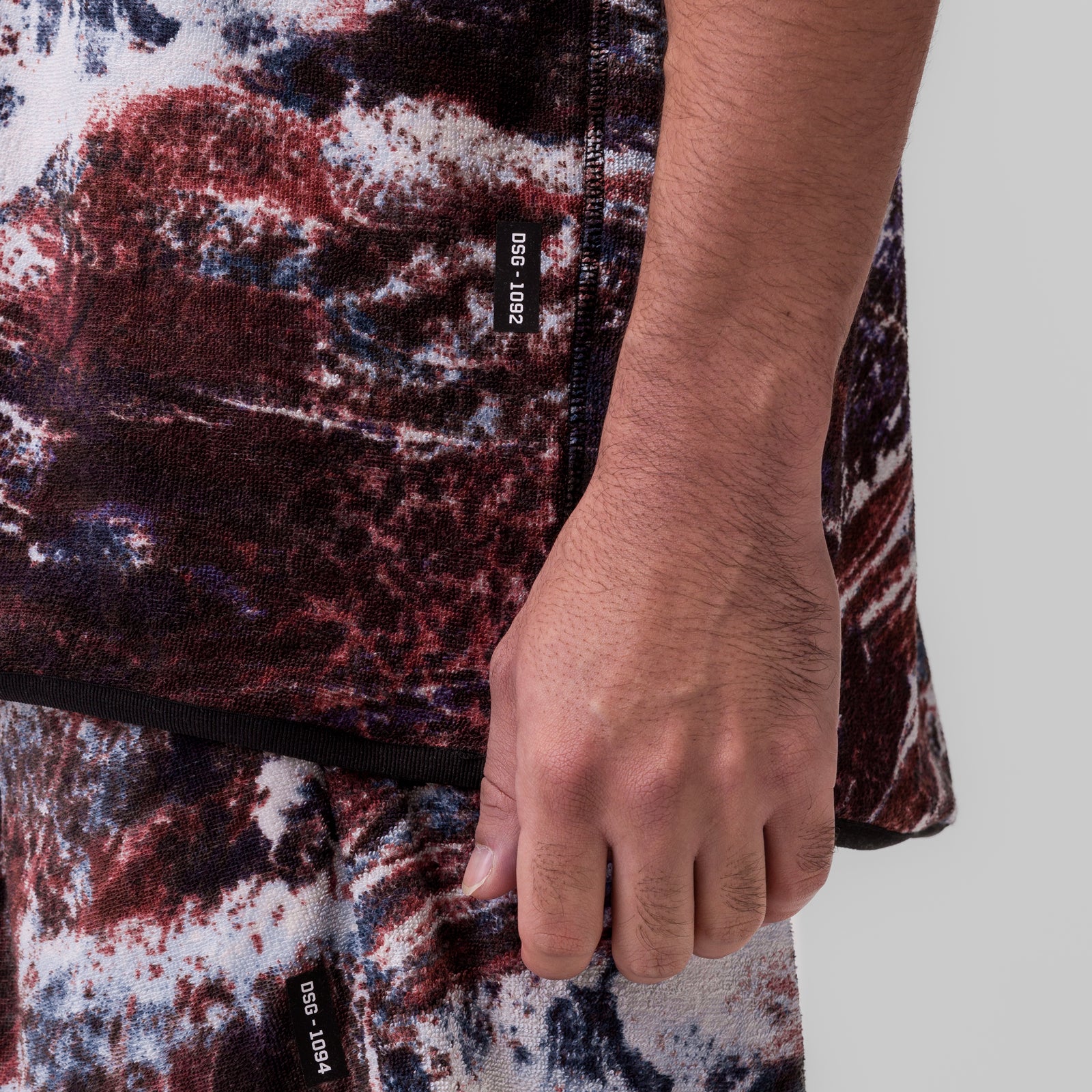 Towel Terry Cutoff in red camo print, modeled on person showing side detail