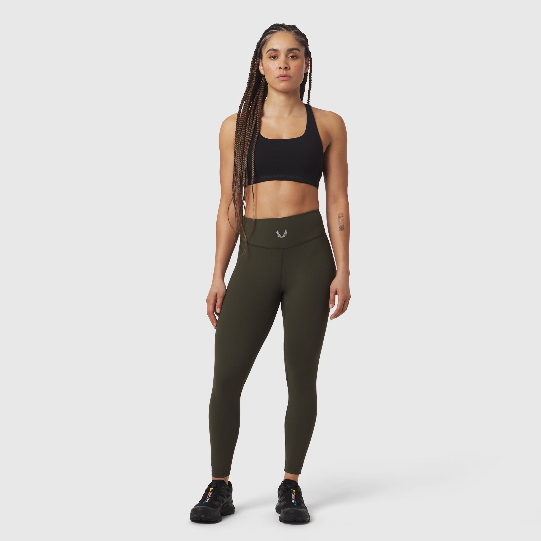 W002 LYCRA® ADAPTIV Legging in olive, worn by model in front pose with sports bra