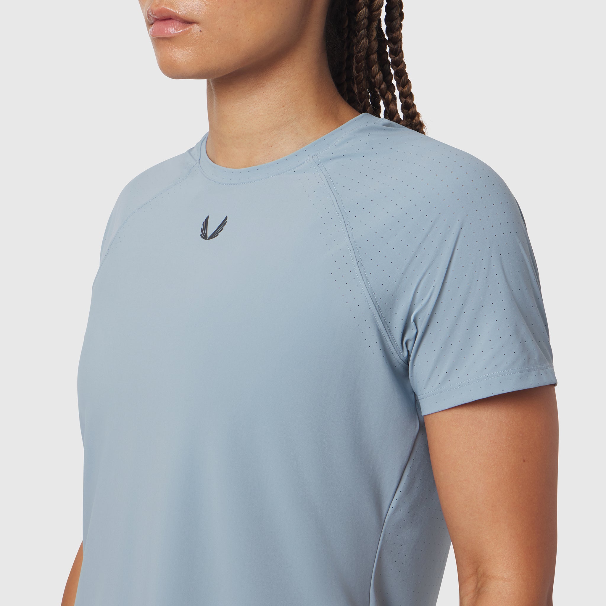 Light Sky Laser-Vent Established Tee worn by model, side view showing perforated fabric detail
