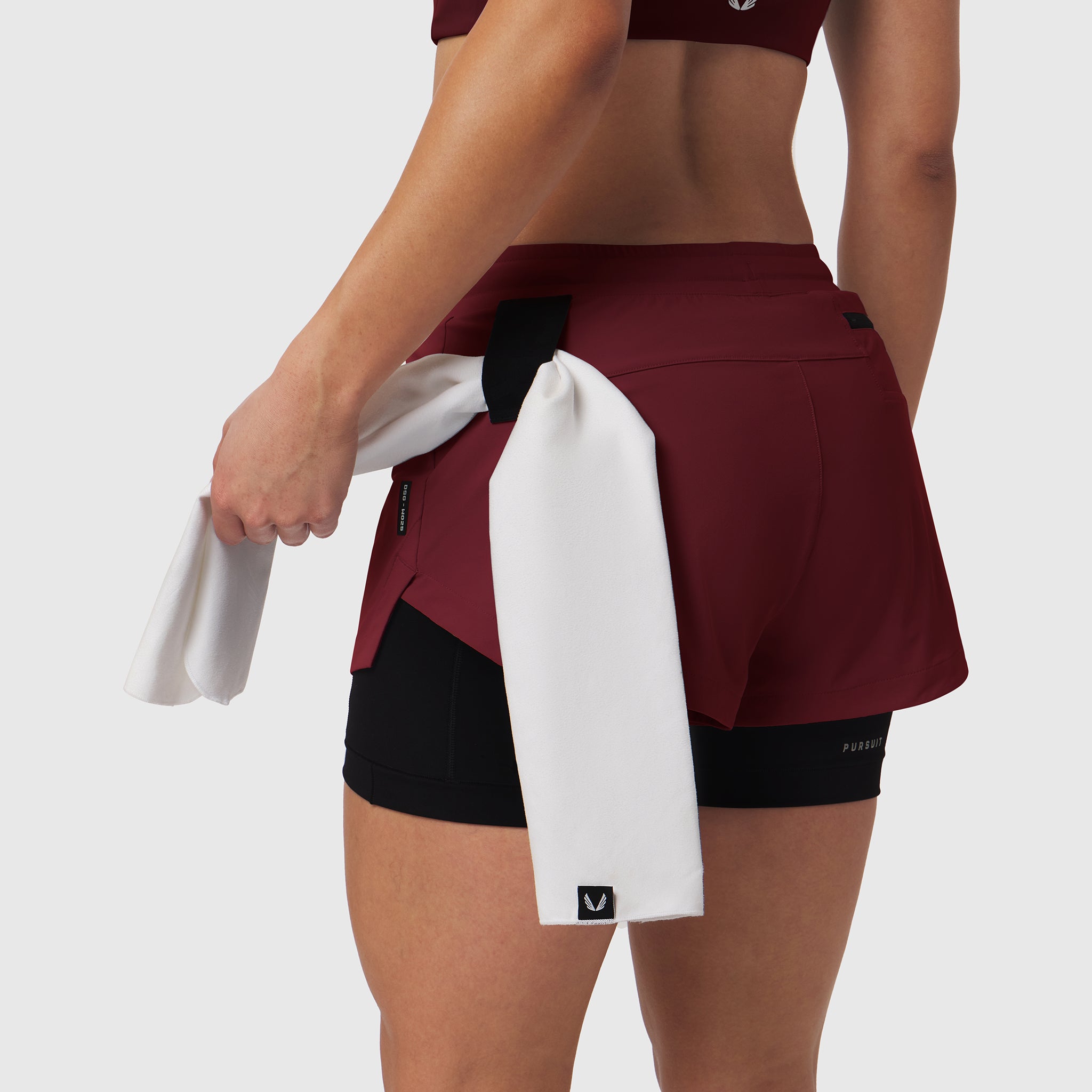 Tetra-Lite Liner Short in crimson worn by model holding white towel, back view