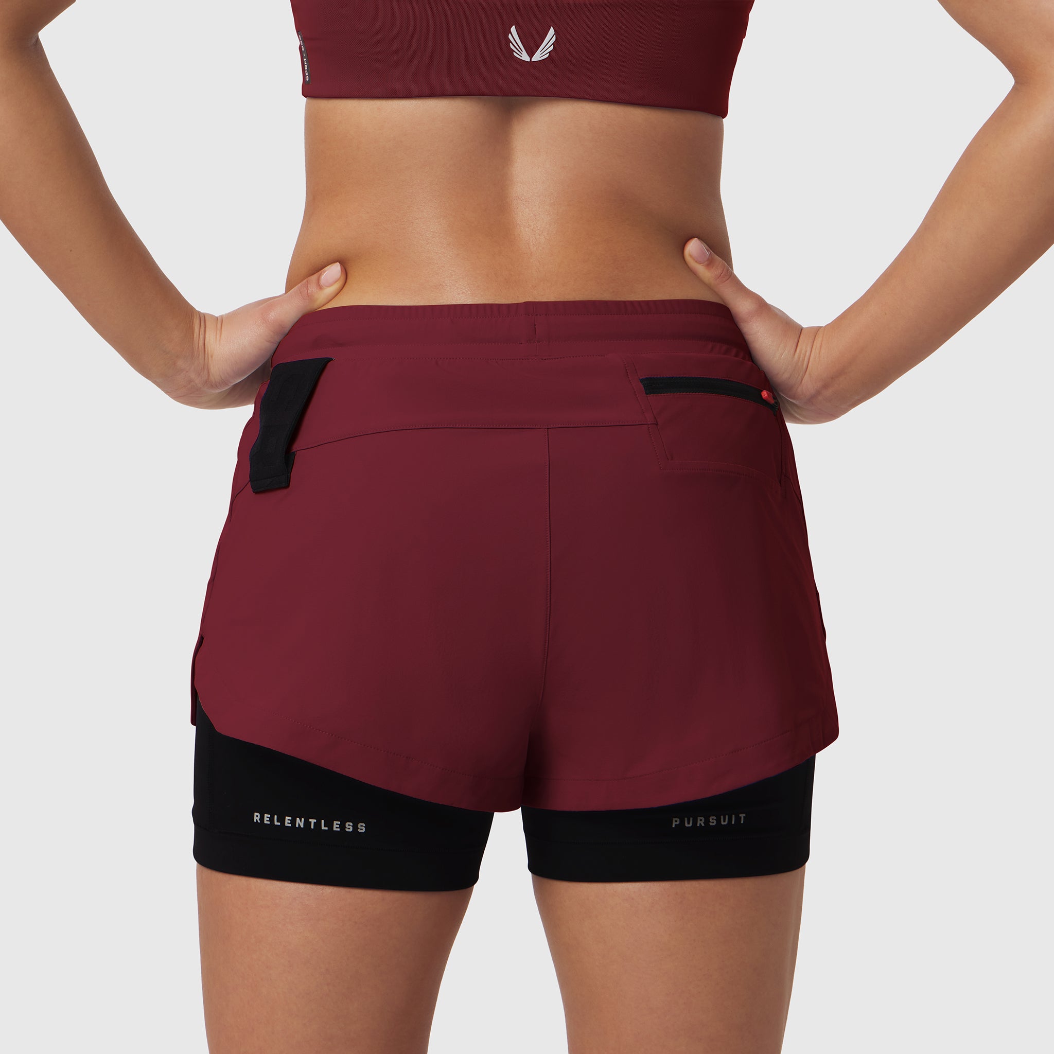 W025 Tetra-Lite Liner Short in crimson and black, back view on model