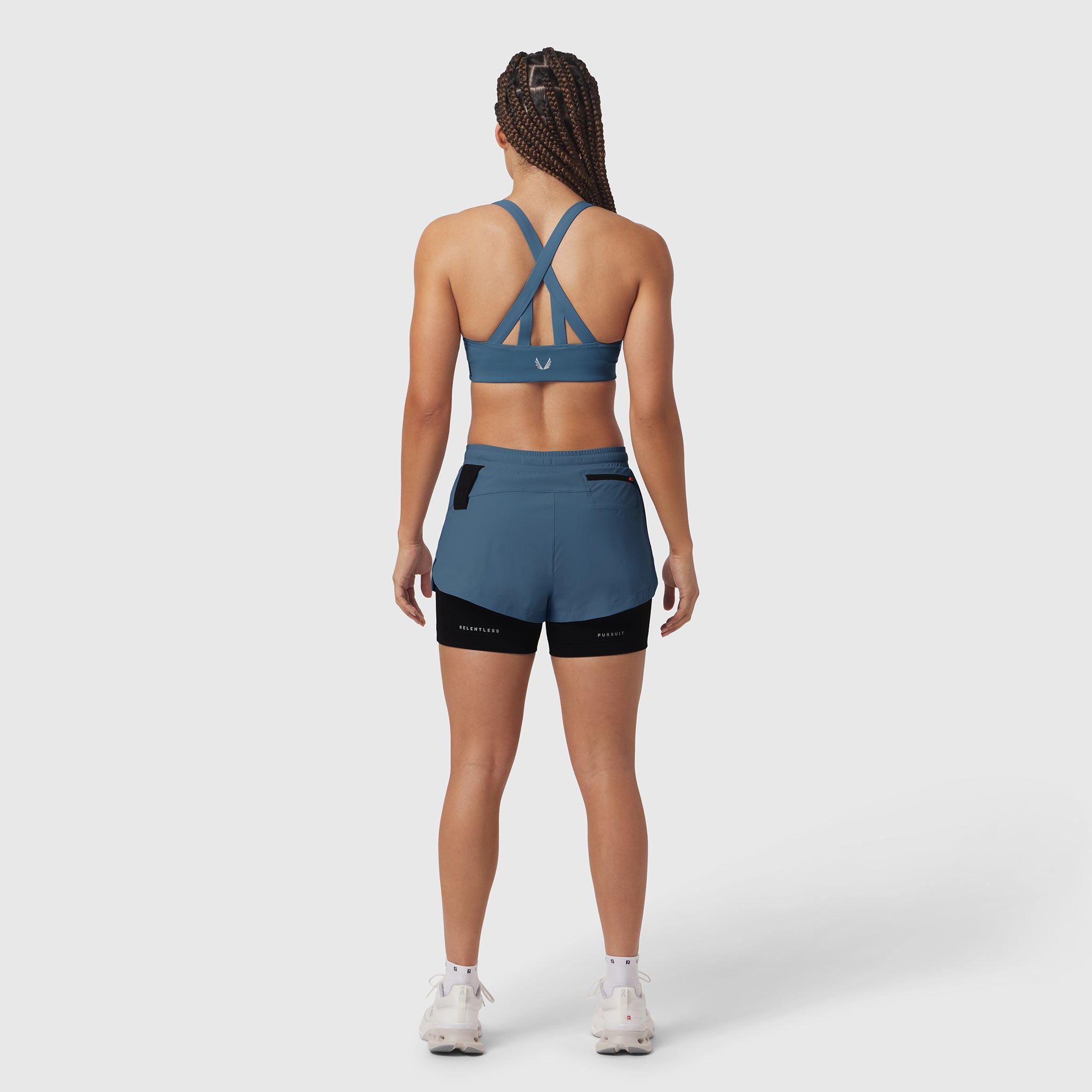 Tetra-Lite Liner Short in storm blue and black, rear view on model