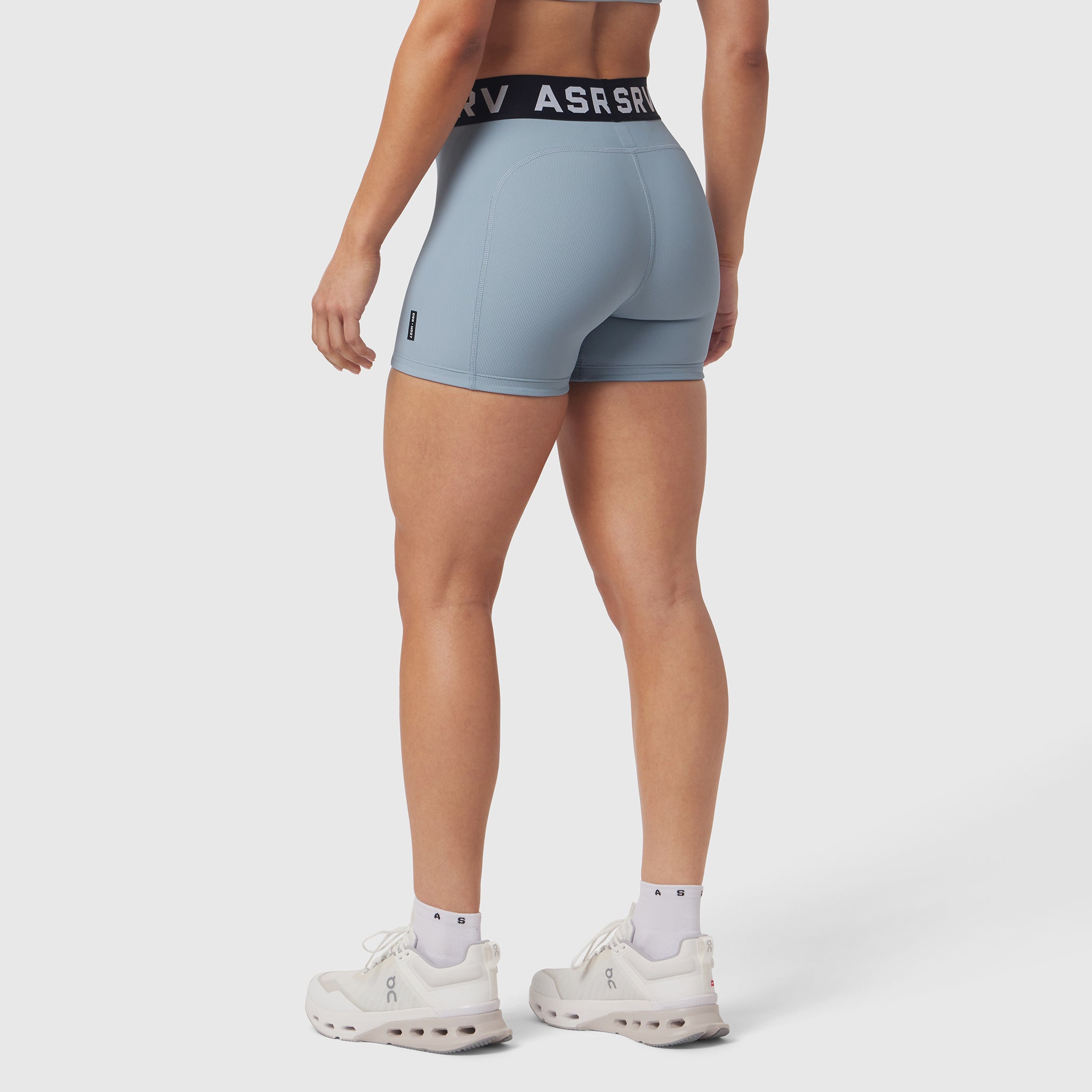 LYCRA® Ribbed Short in light sky, worn by model from behind, paired with white sneakers