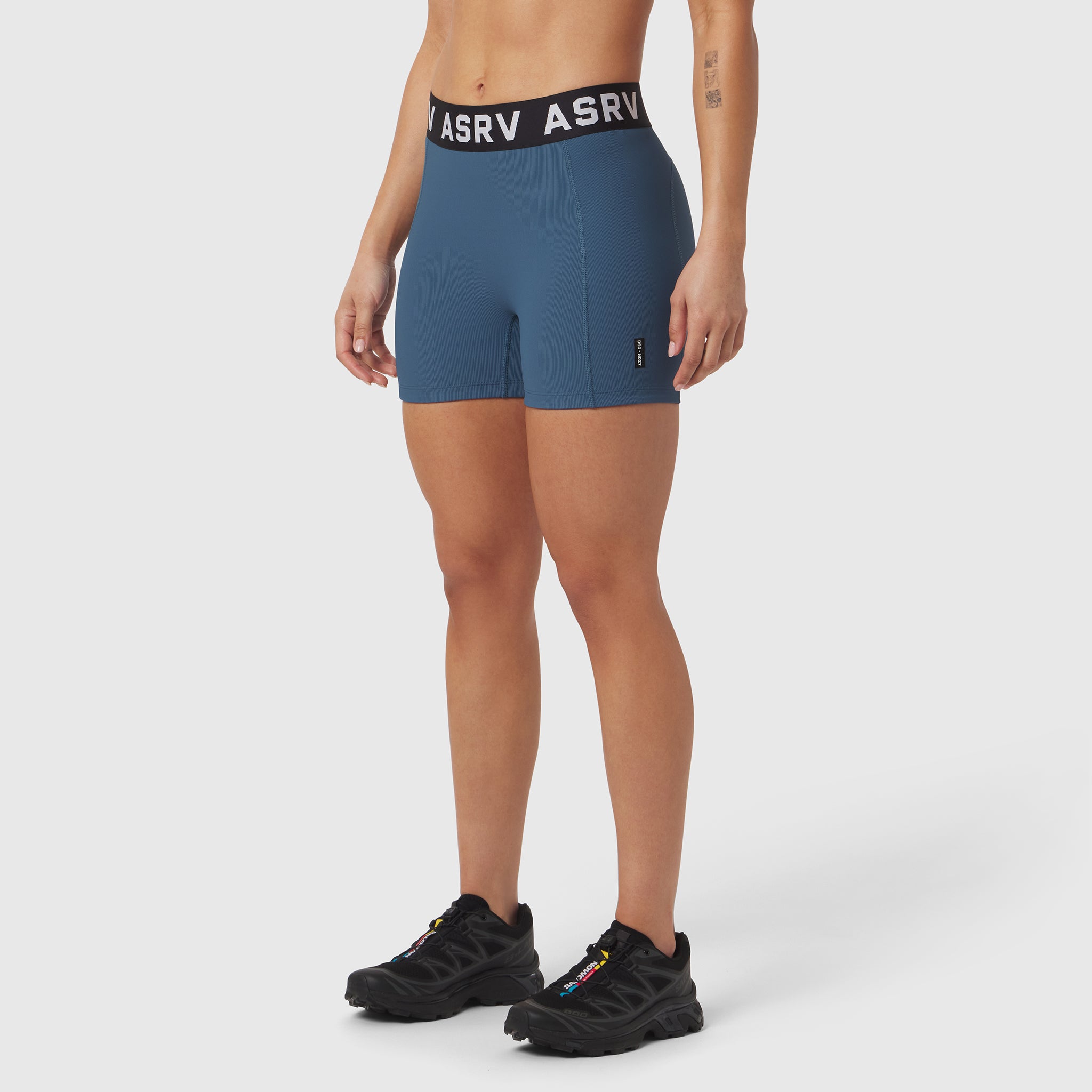 W027 Lycra Ribbed Short in storm blue, modeled with black sneakers, front view