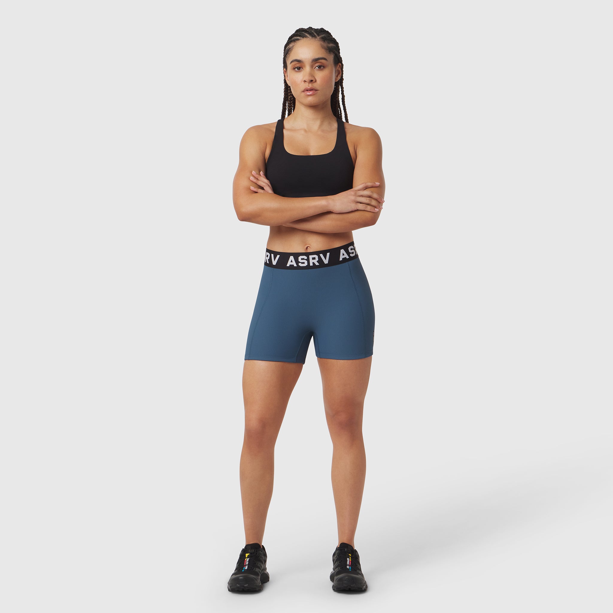 W027 Lycra Ribbed Short in storm blue, worn by model with arms crossed