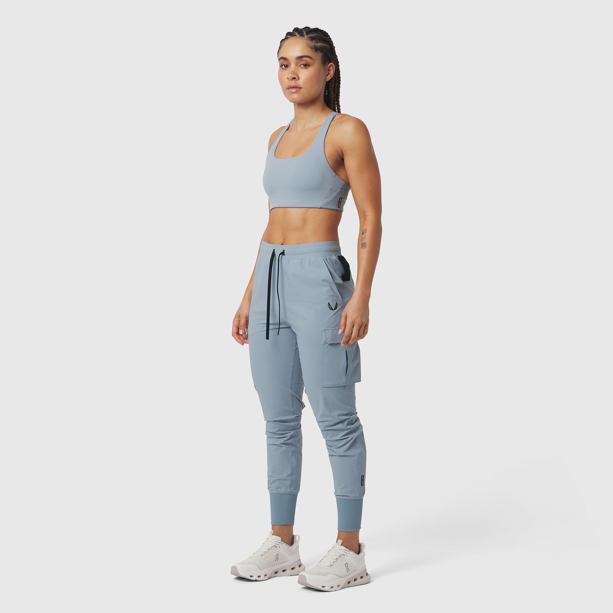 W032 Tetra-Lite Cargo High Rib Jogger in light sky, worn by model in sports bra, front view