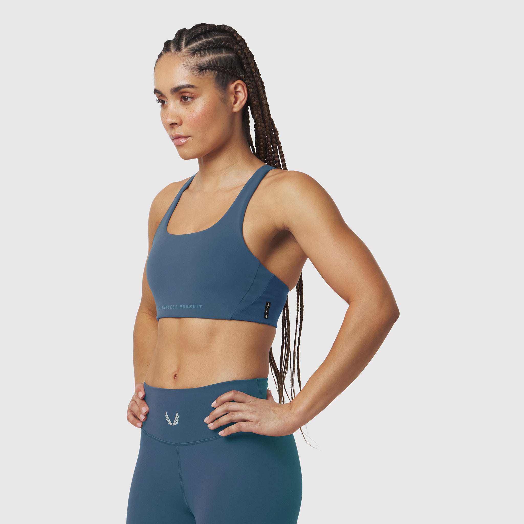 W039 Lycra Hybrid Sports Bra in storm blue, worn by model in side profile