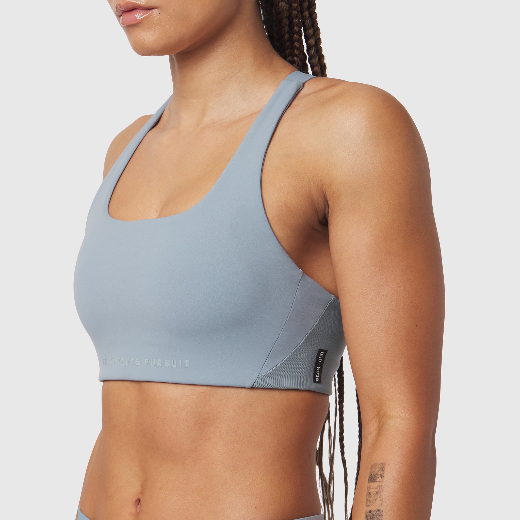 LYCRA® Hybrid Sports Bra in Light Sky, worn by model in side profile view