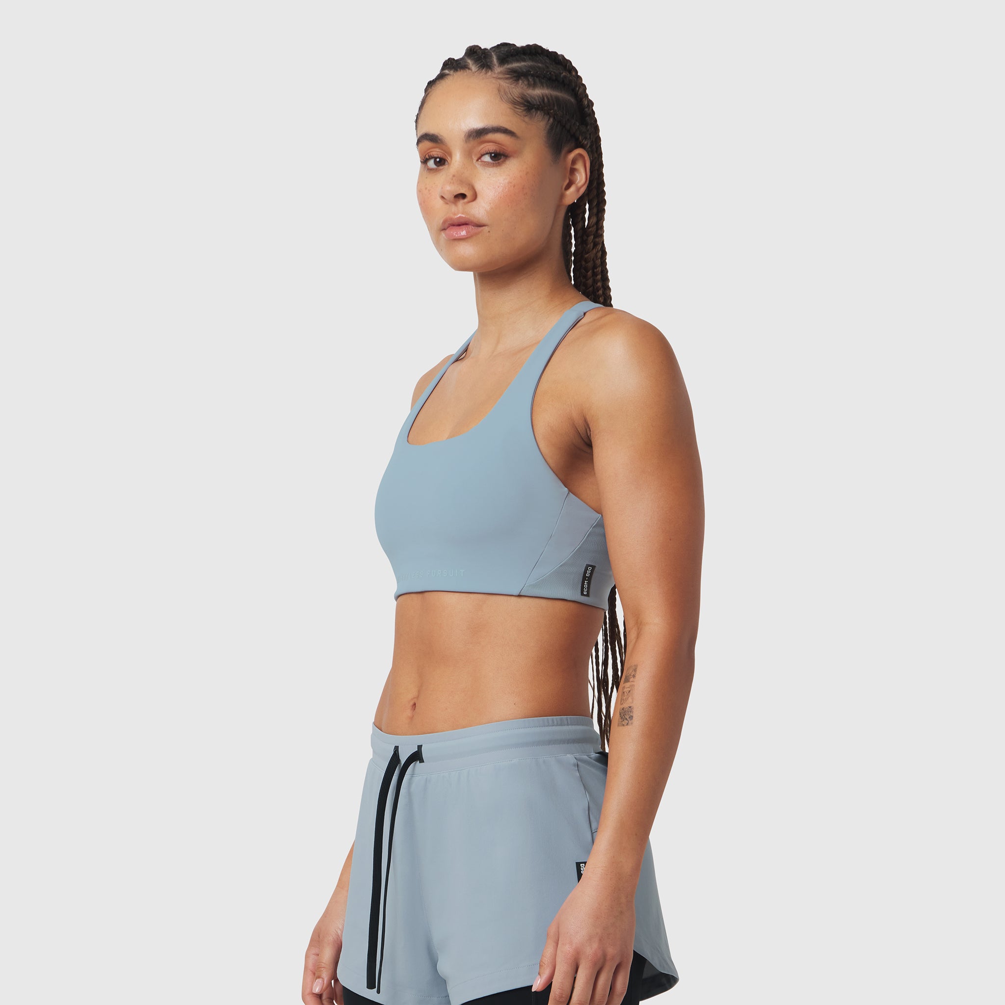 LYCRA® Hybrid Sports Bra in light sky, worn by model in side profile pose