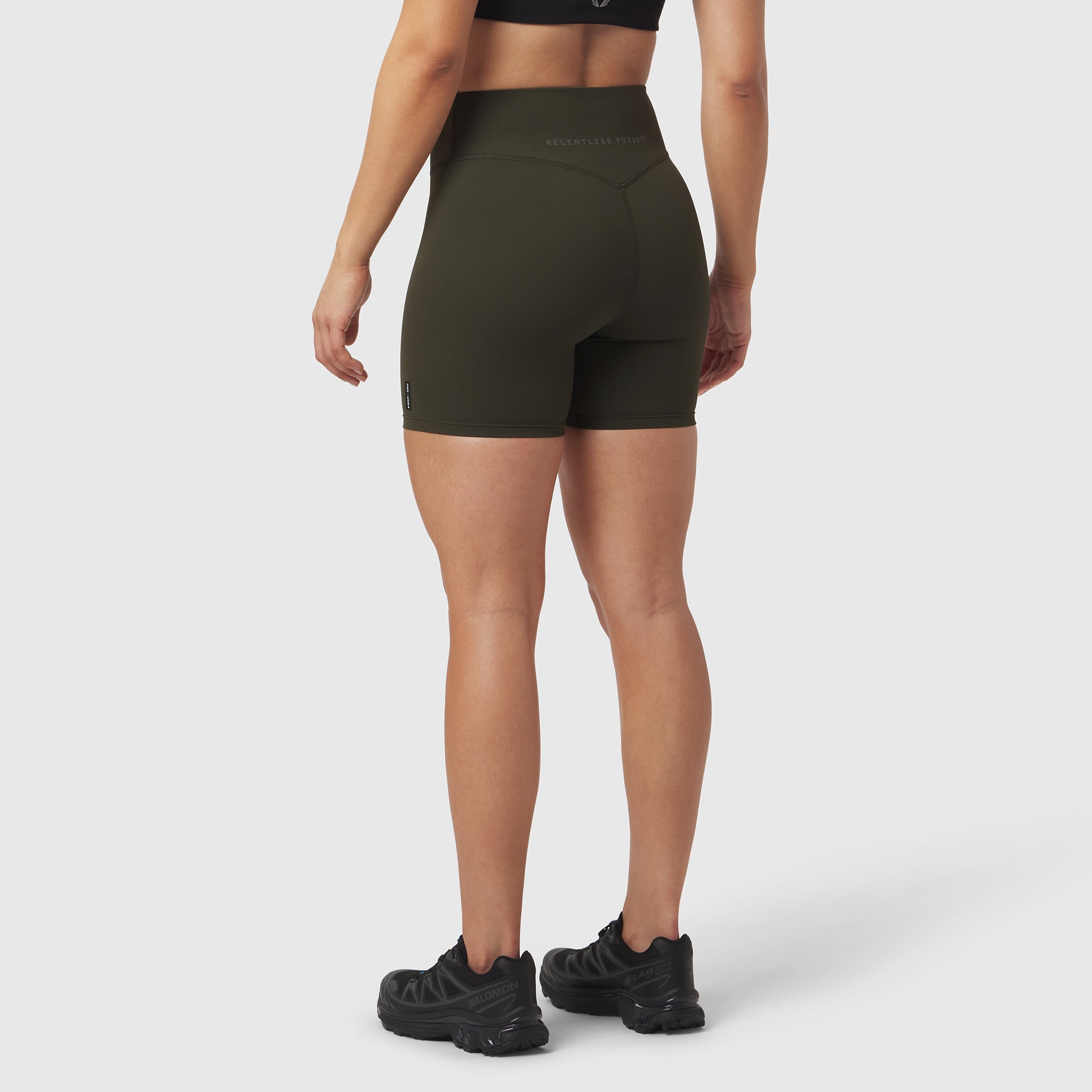 LYCRA® ADAPTIV Biker Short in olive, worn by model shown from behind