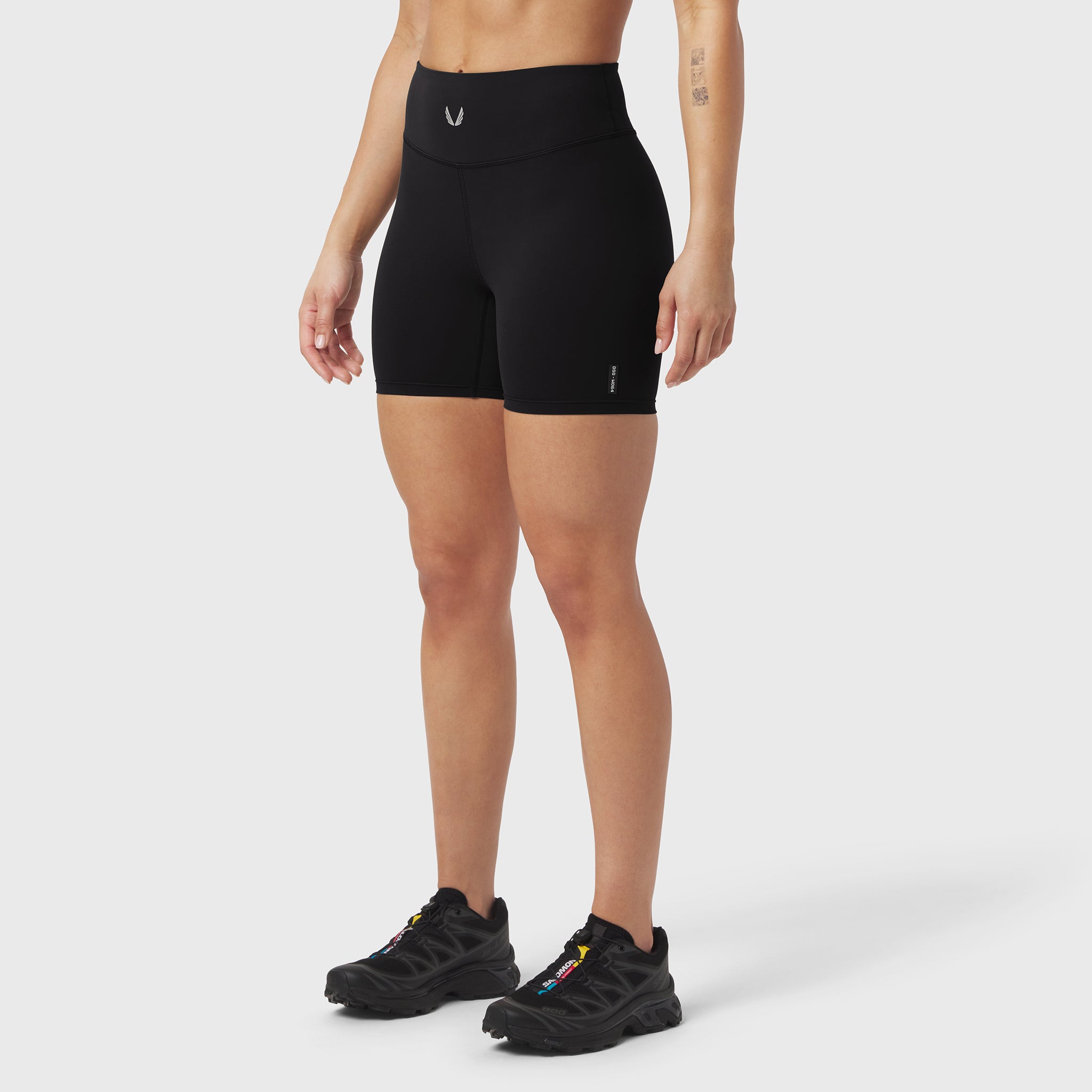 Black LYCRA® ADAPTIV biker shorts worn by model, front view