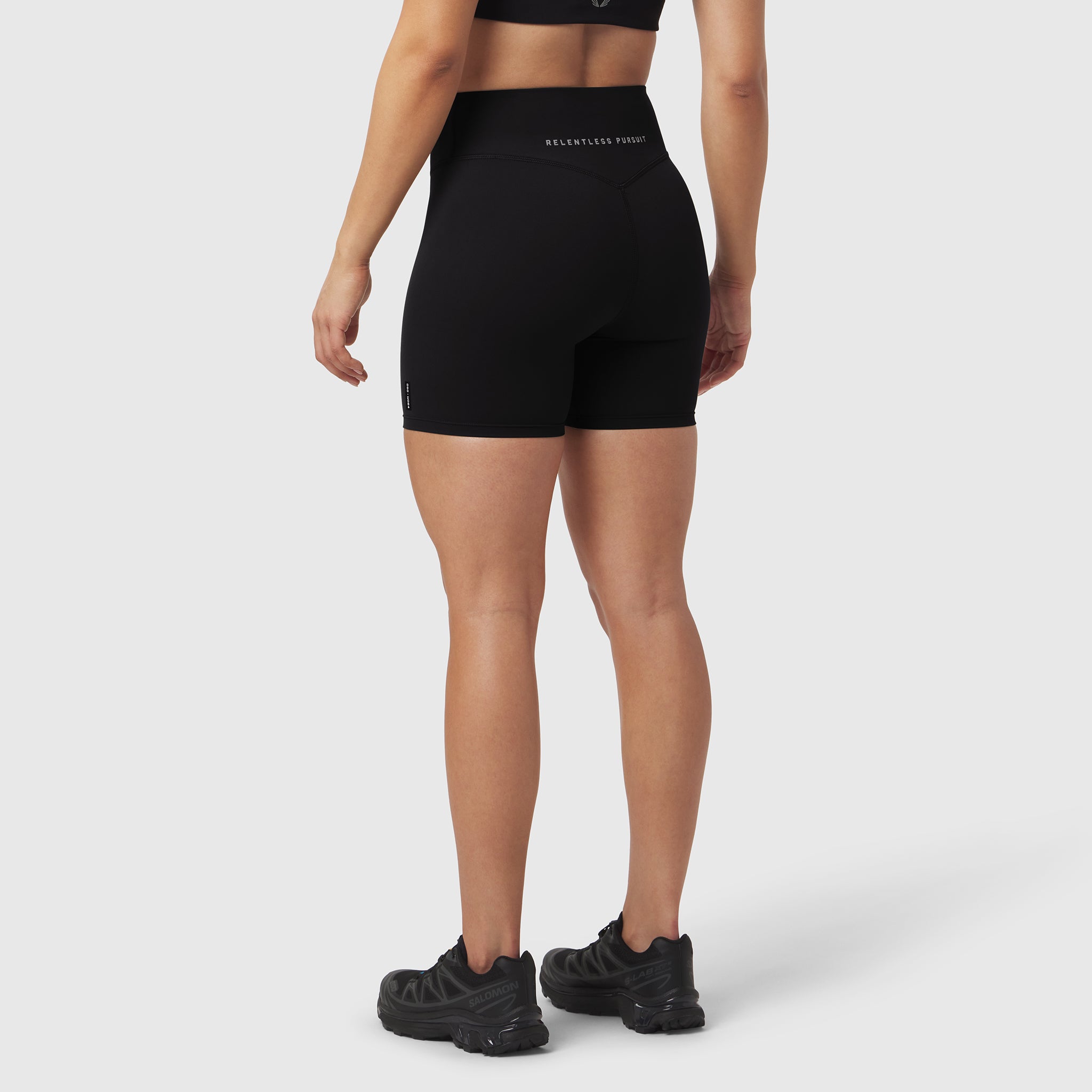 Black LYCRA® ADAPTIV biker shorts on model, rear view