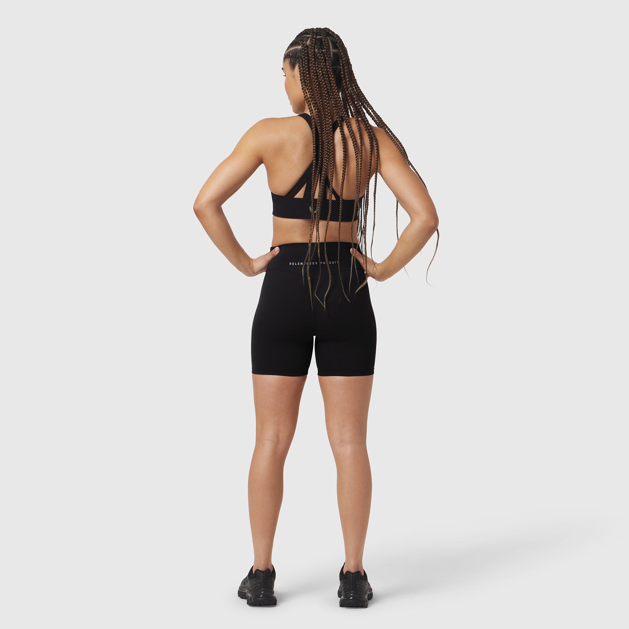 Black LYCRA® ADAPTIV biker shorts worn by model, back view