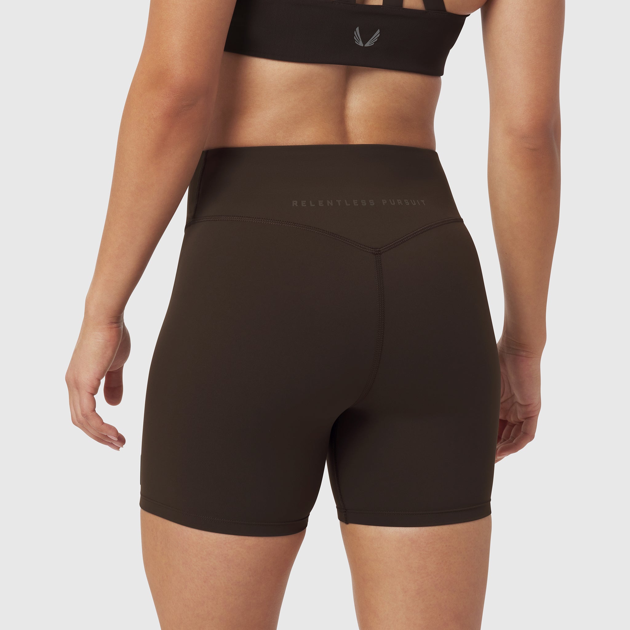 LYCRA® ADAPTIV Biker Short in Dark Earth, worn by model, back view
