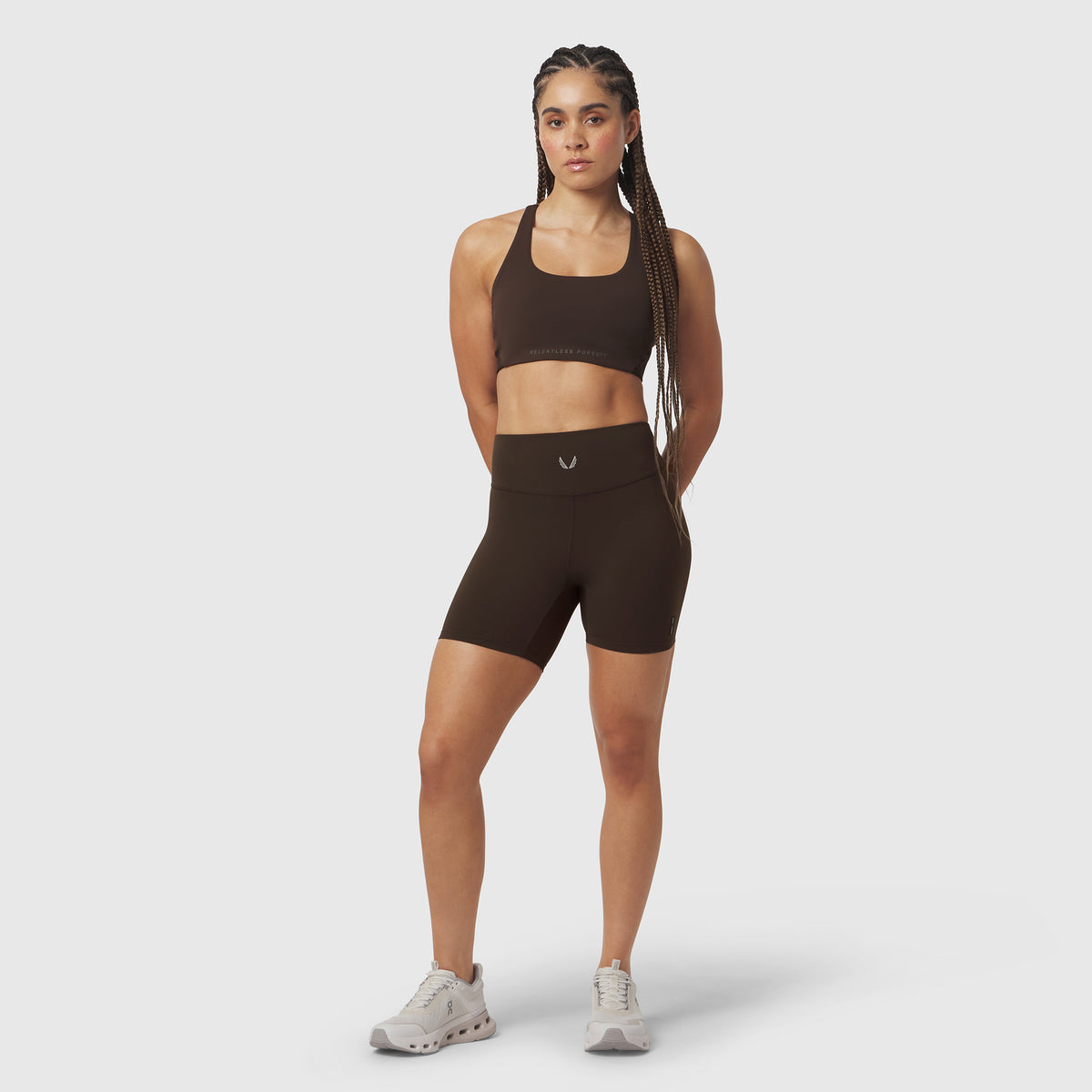 LYCRA® ADAPTIV Biker Short in Dark Earth, worn with matching sports bra, front view