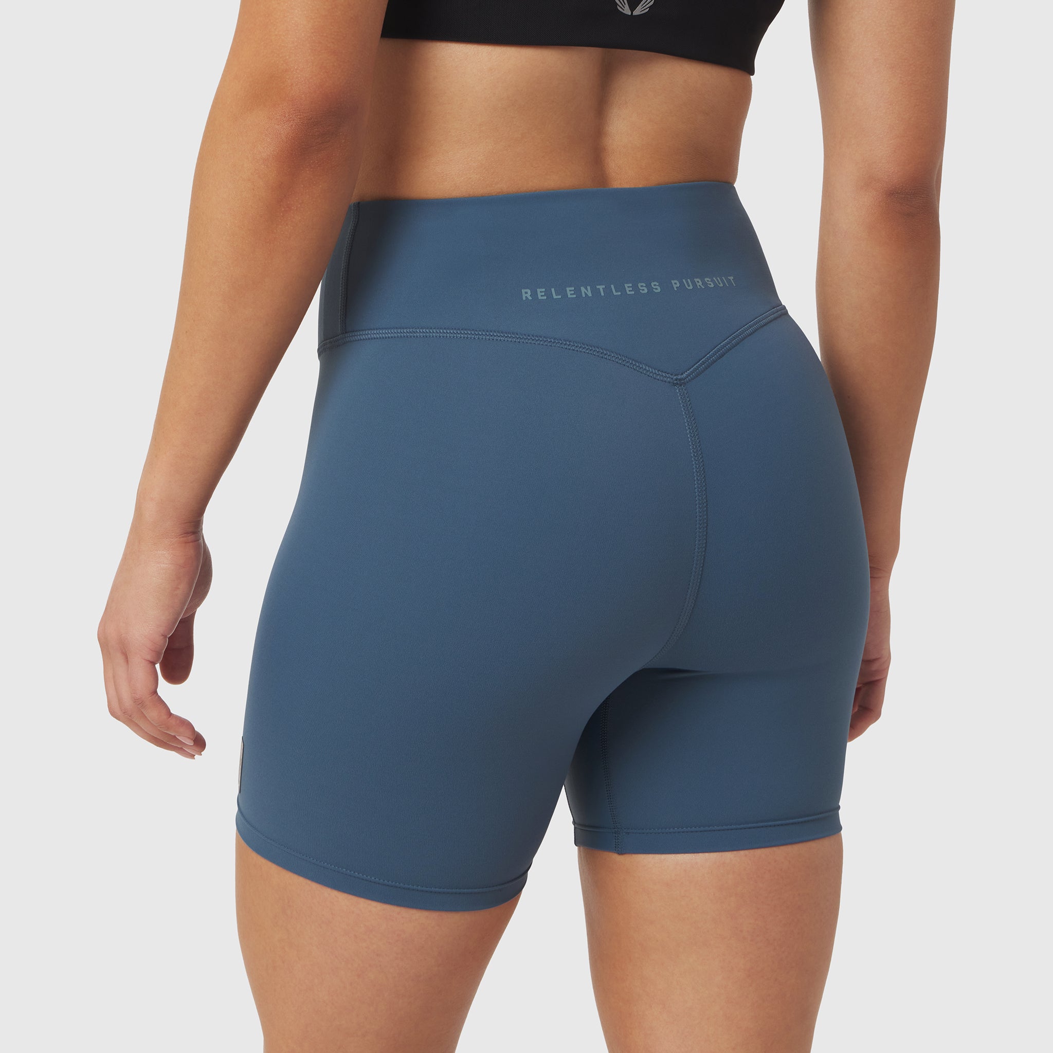 W064 LYCRA® ADAPTIV Biker Short in Storm blue, worn by model, back view