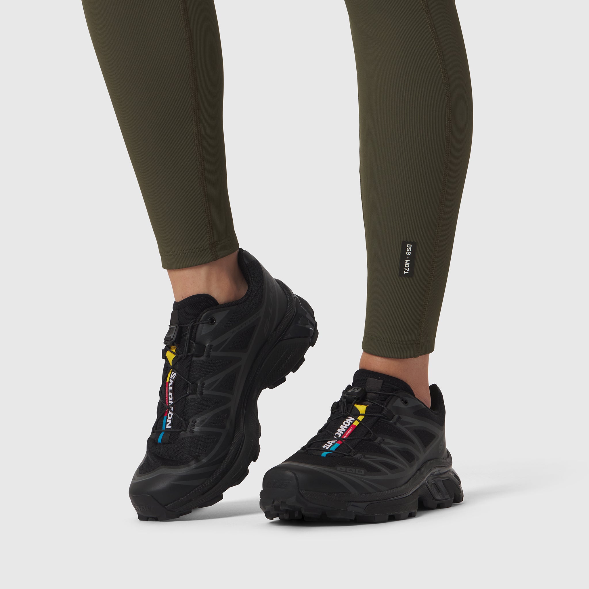 W071 Lycra Ribbed Legging in olive worn with black sneakers, legs visible