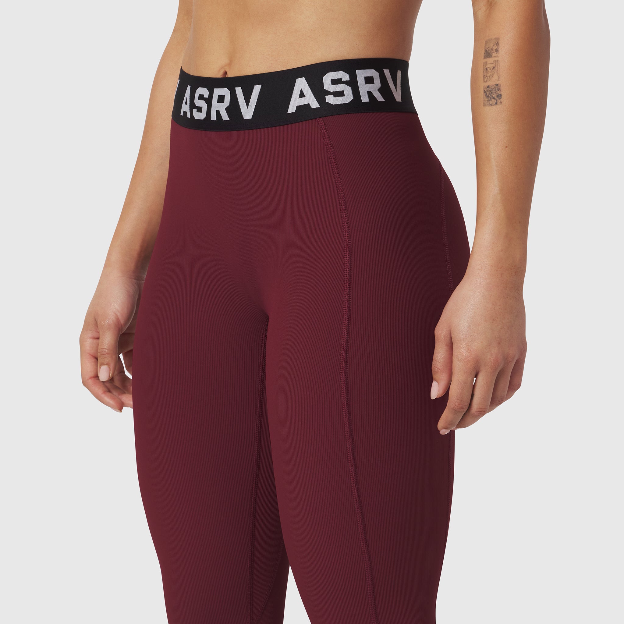 W071 LYCRA® Ribbed Legging in crimson, modeled from waist down showing fitted silhouette