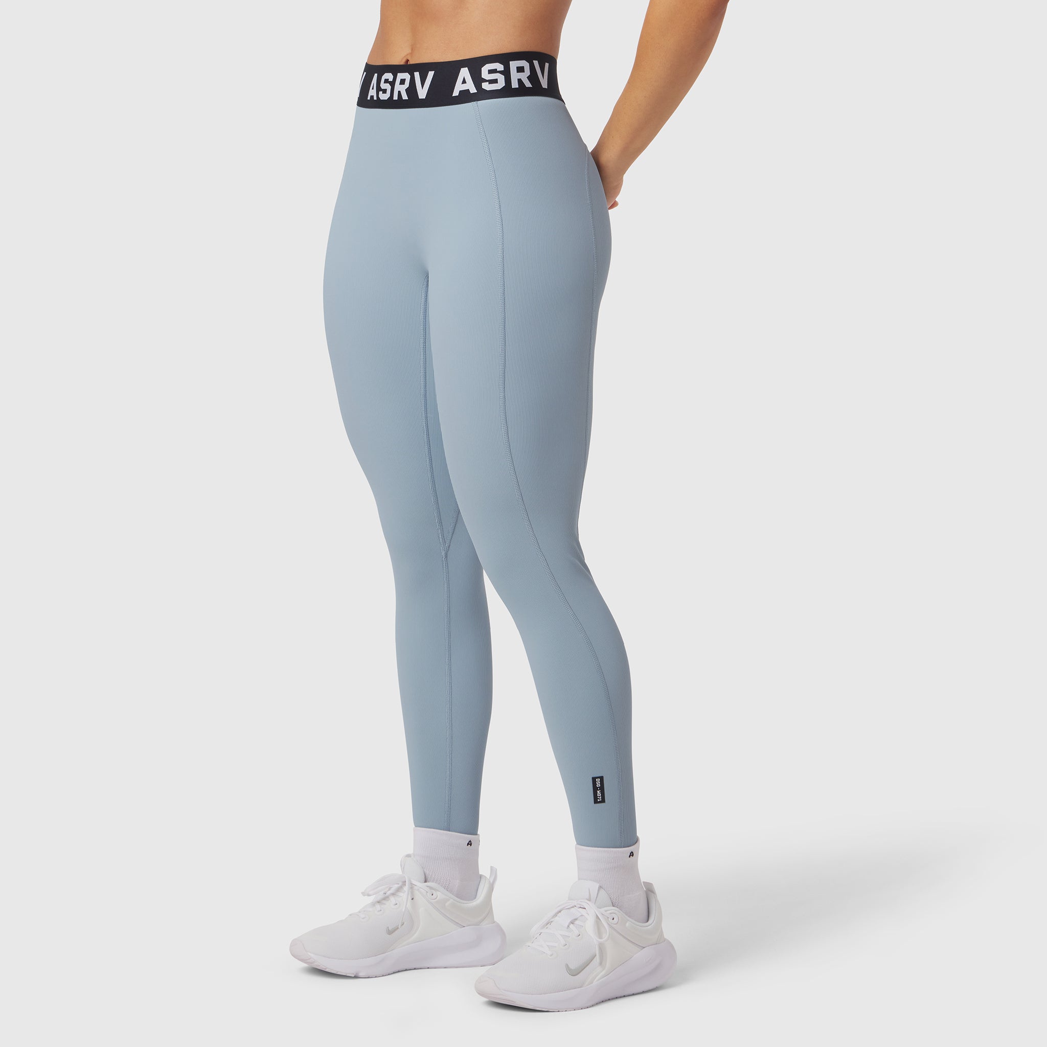 W071 Lycra Ribbed Legging in light sky, worn with white sneakers, side view
