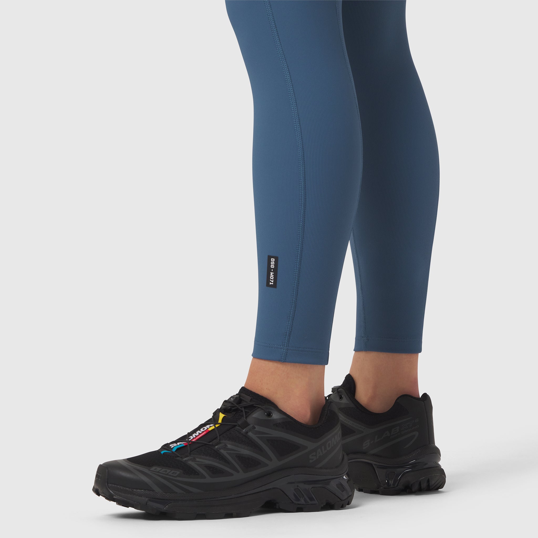 W071 Lycra Ribbed Legging in storm blue, worn with black sneakers, side view
