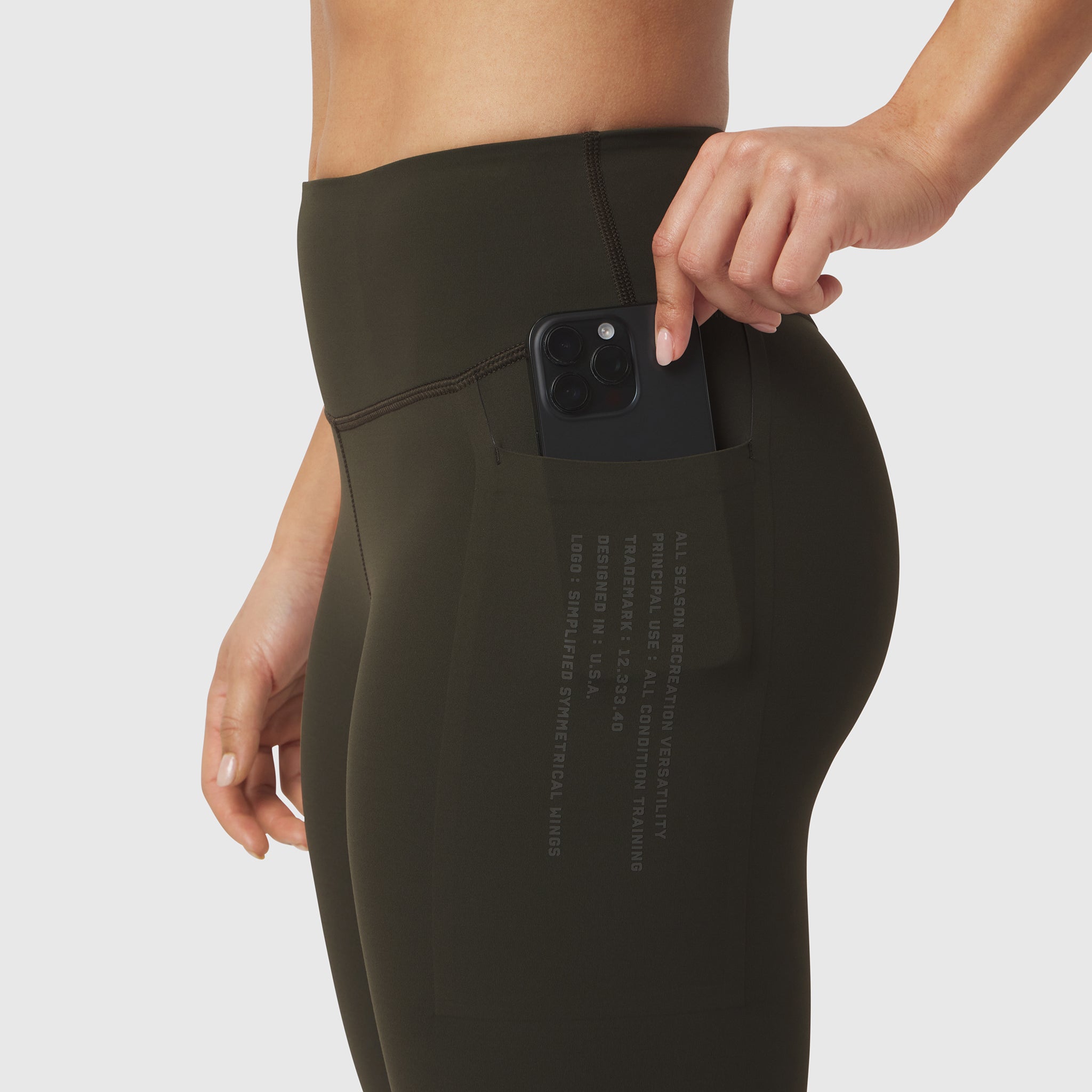 W072 LYCRA® ADAPTIV 4 Pocket Legging in olive, model demonstrating phone pocket