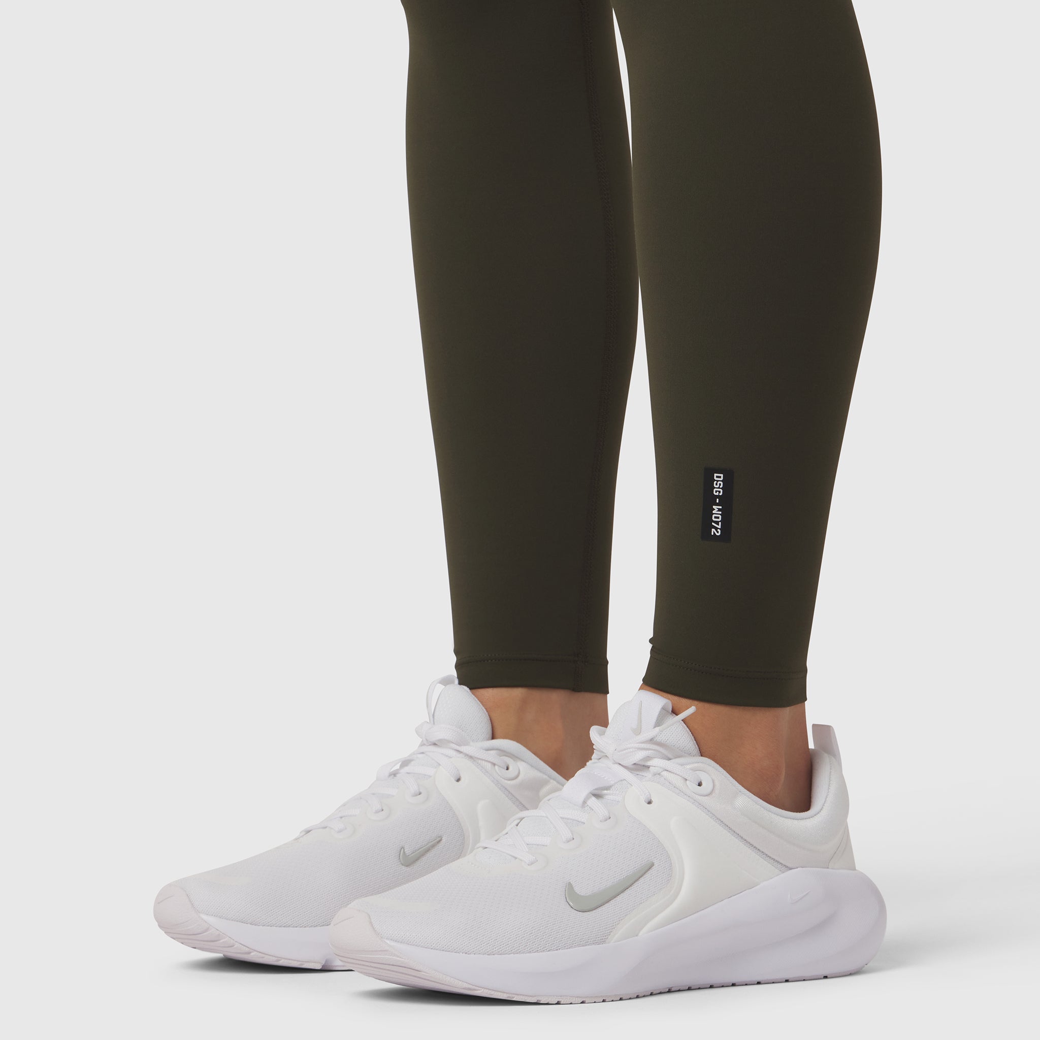 W072 LYCRA® ADAPTIV 4 Pocket Legging in olive worn with white sneakers, lower body view