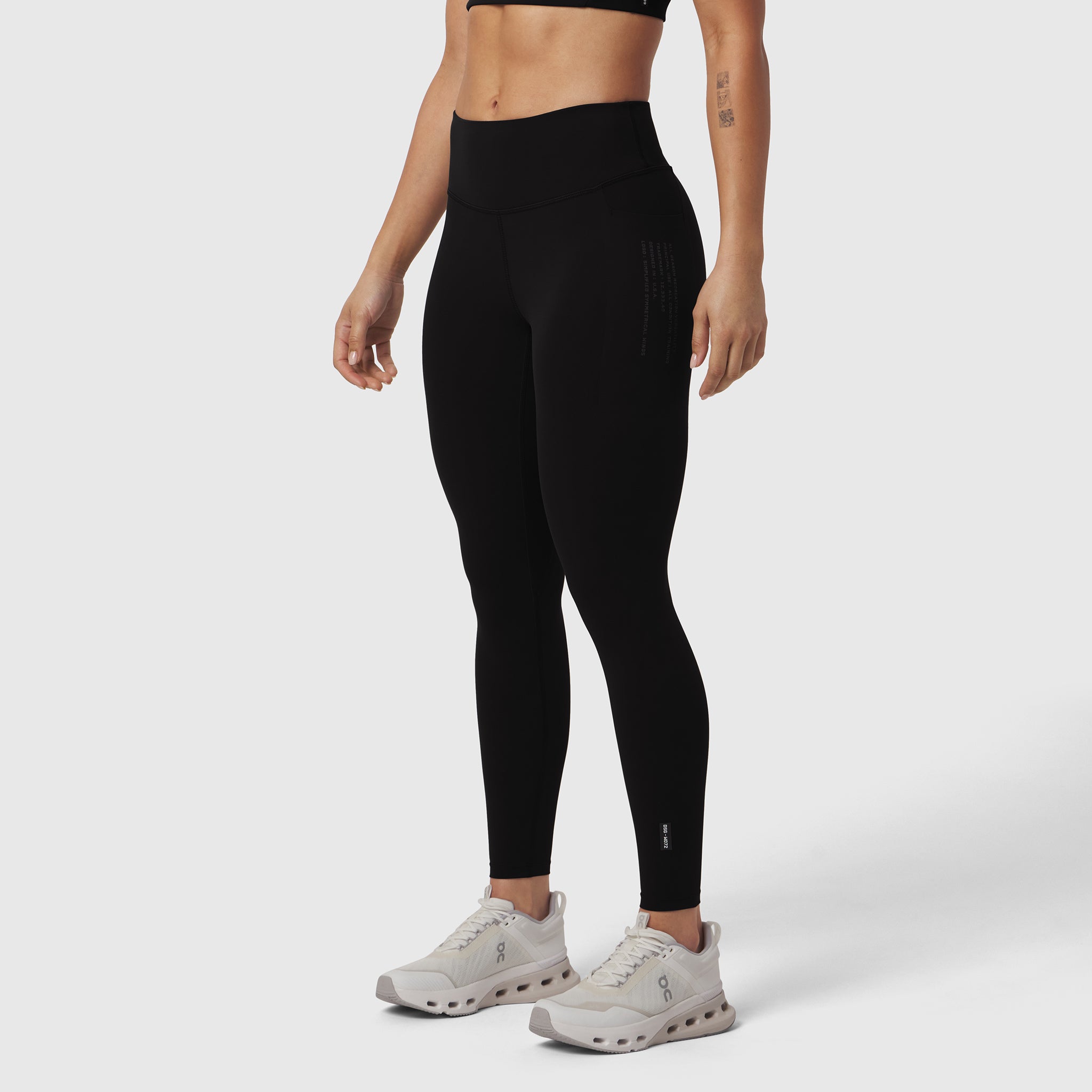 Black LYCRA® ADAPTIV 4 Pocket Legging worn by model with white sneakers, side view