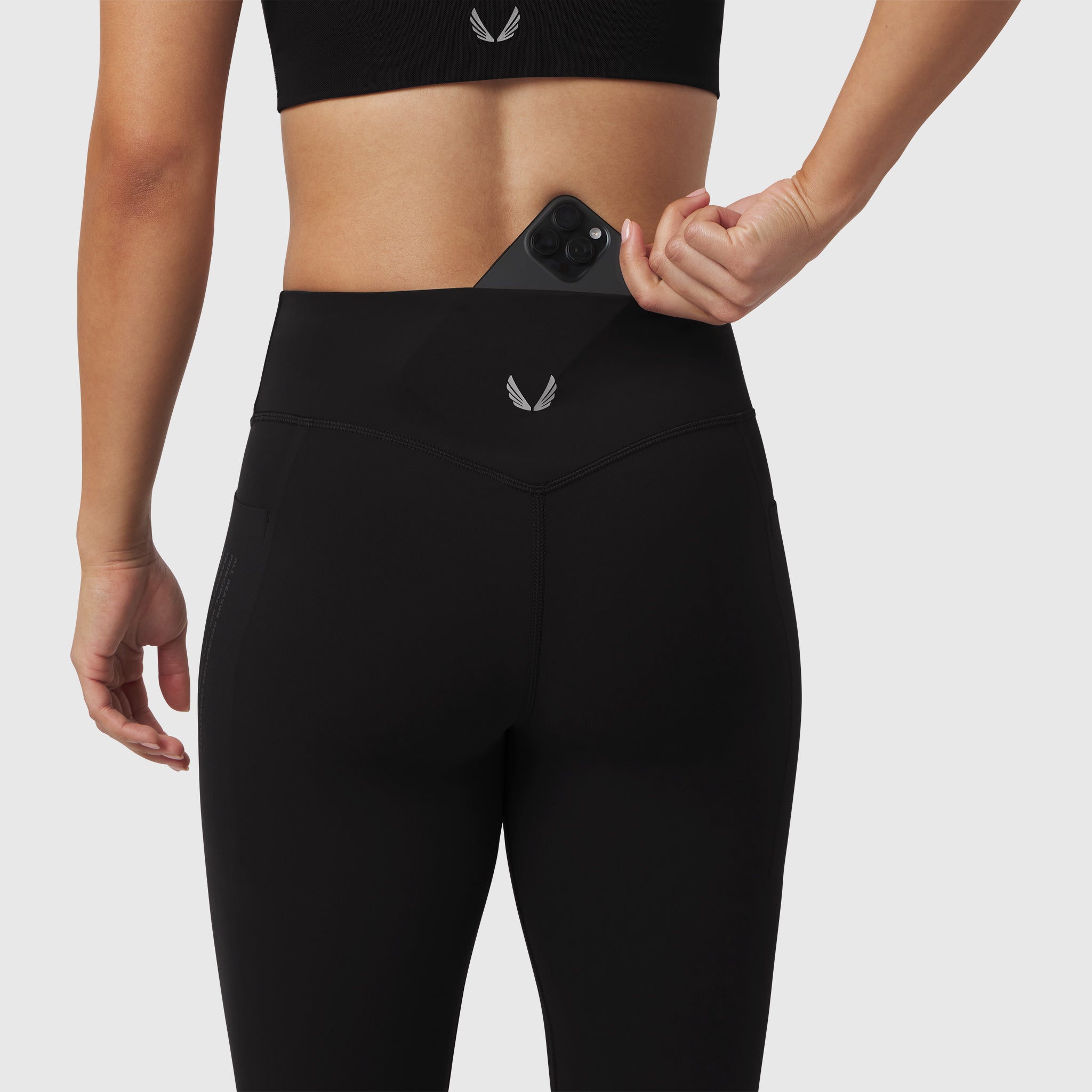 Black Lycra Adaptiv 4 Pocket Legging worn by model, demonstrating phone pocket feature