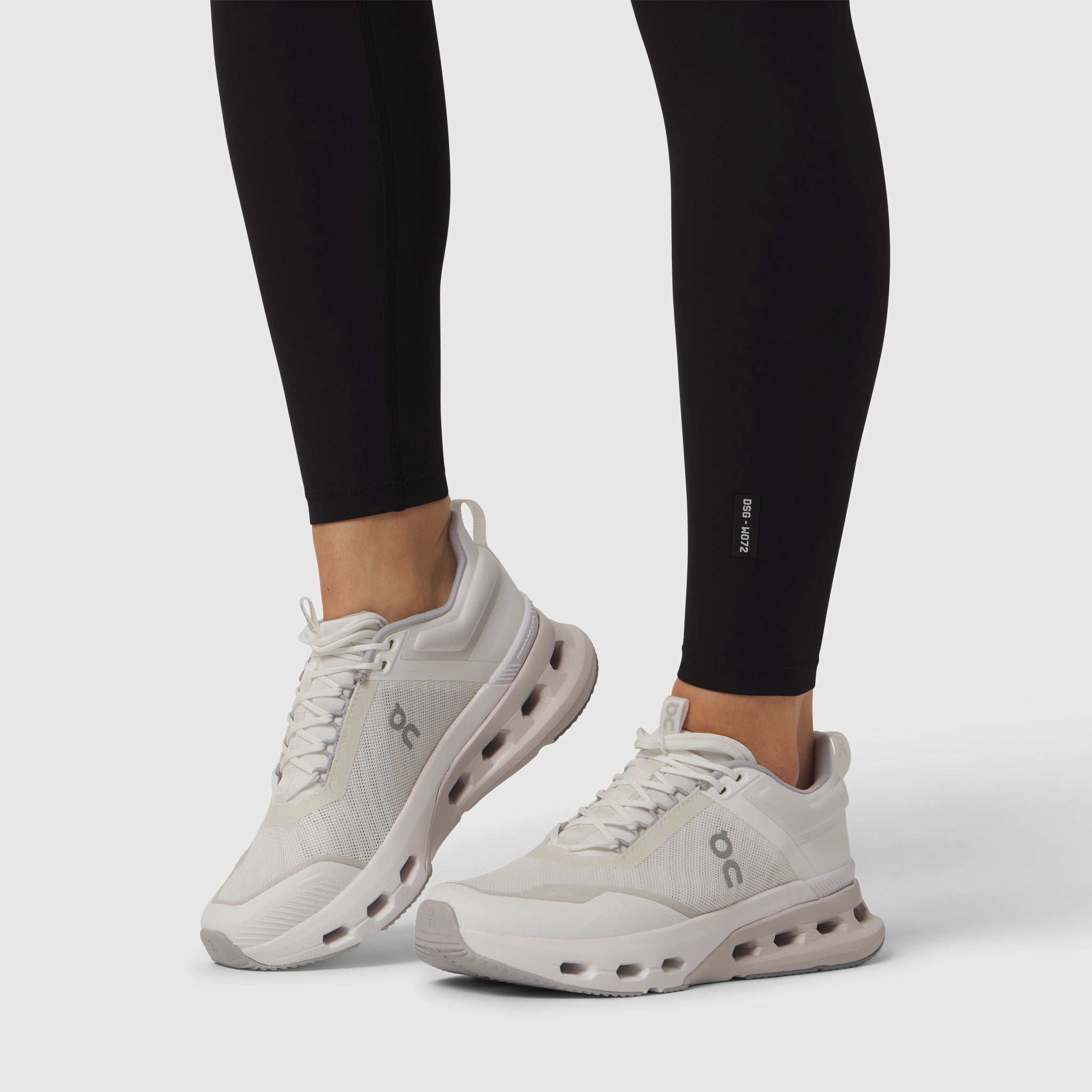 White sneakers with CloudTec sole worn with black Lycra Adaptiv leggings, side view