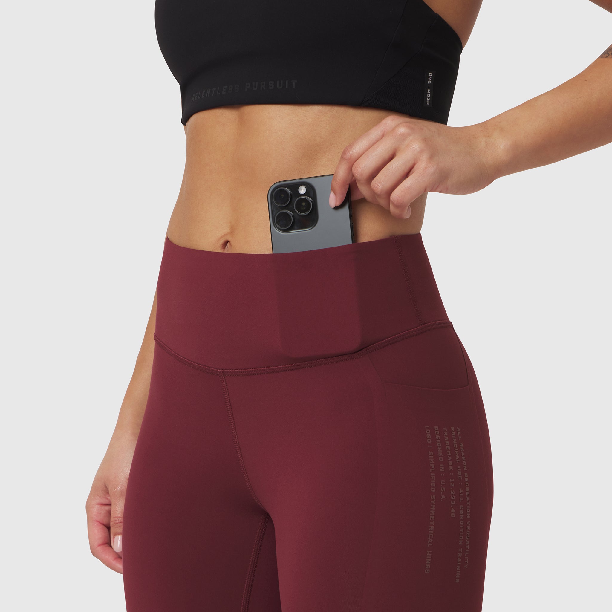 W072 LYCRA® ADAPTIV 4 Pocket Legging in crimson, model wearing legging with phone in pocket