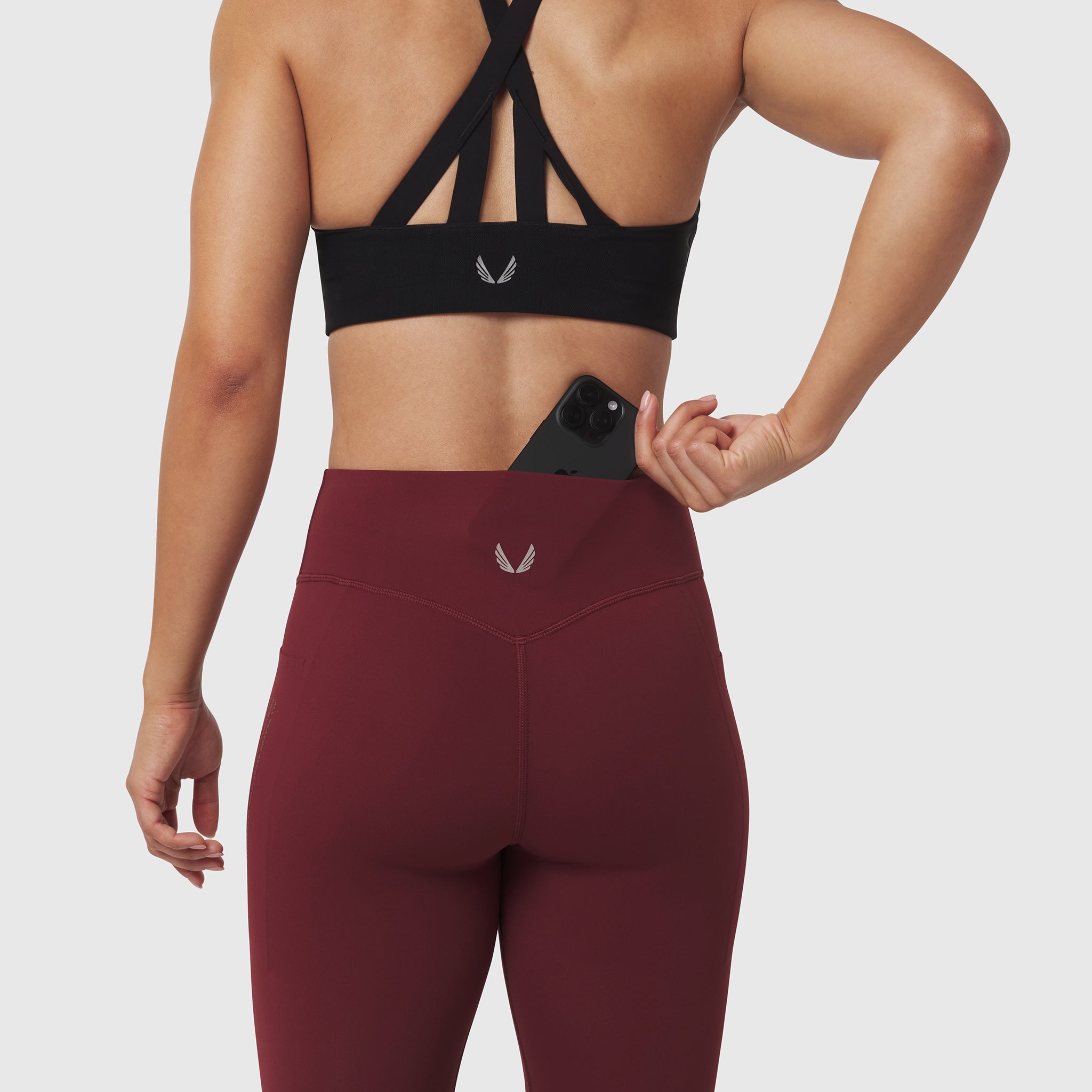 W072 LYCRA® ADAPTIV 4 Pocket Legging in Crimson, back view worn with sports bra
