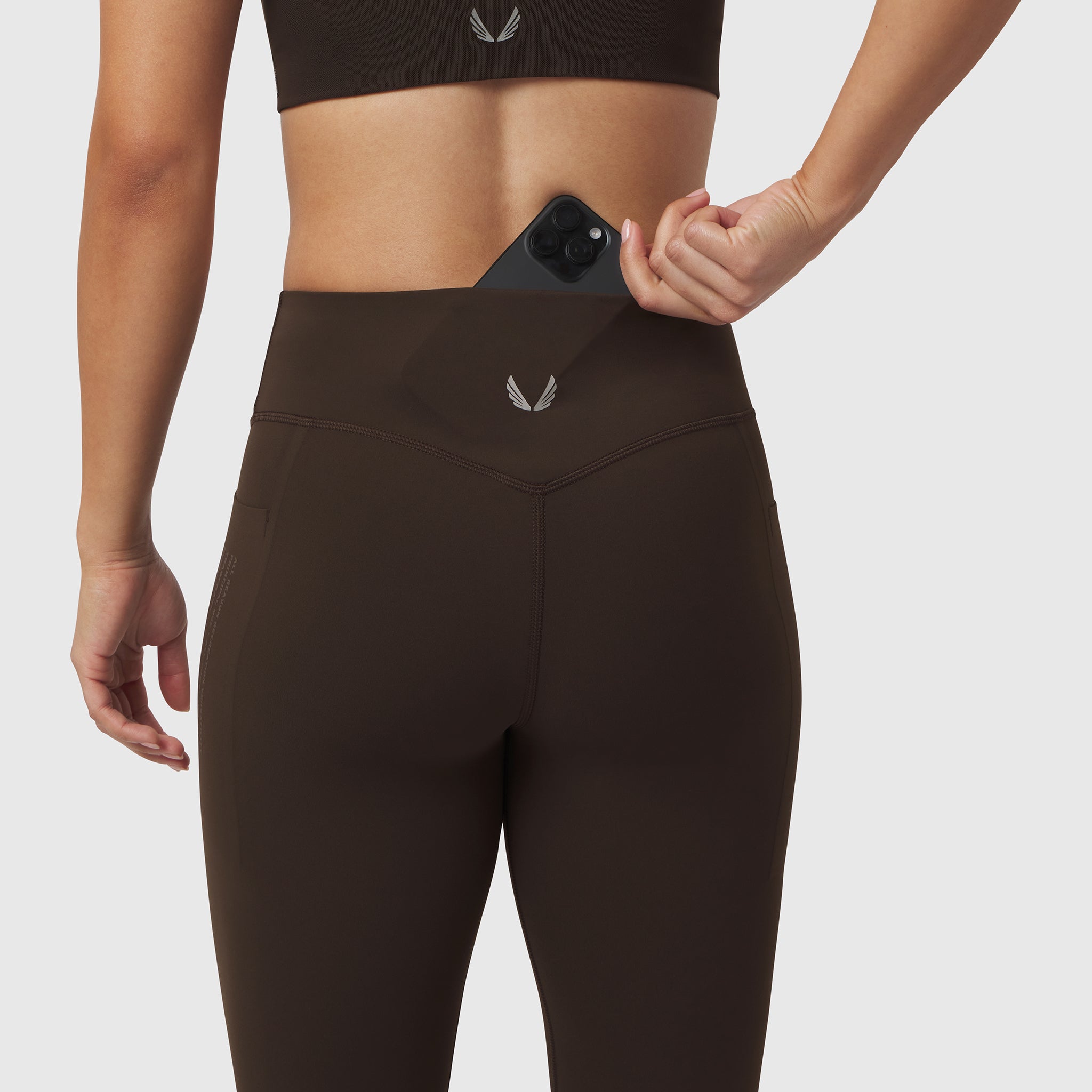 W072 Lycra Adaptiv 4 Pocket Legging in Dark Earth, model wearing with phone in pocket