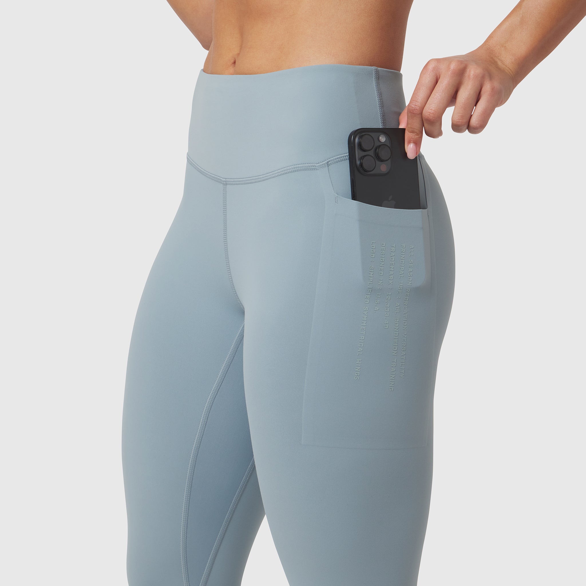 Light sky 4 pocket legging worn by model, demonstrating phone pocket functionality
