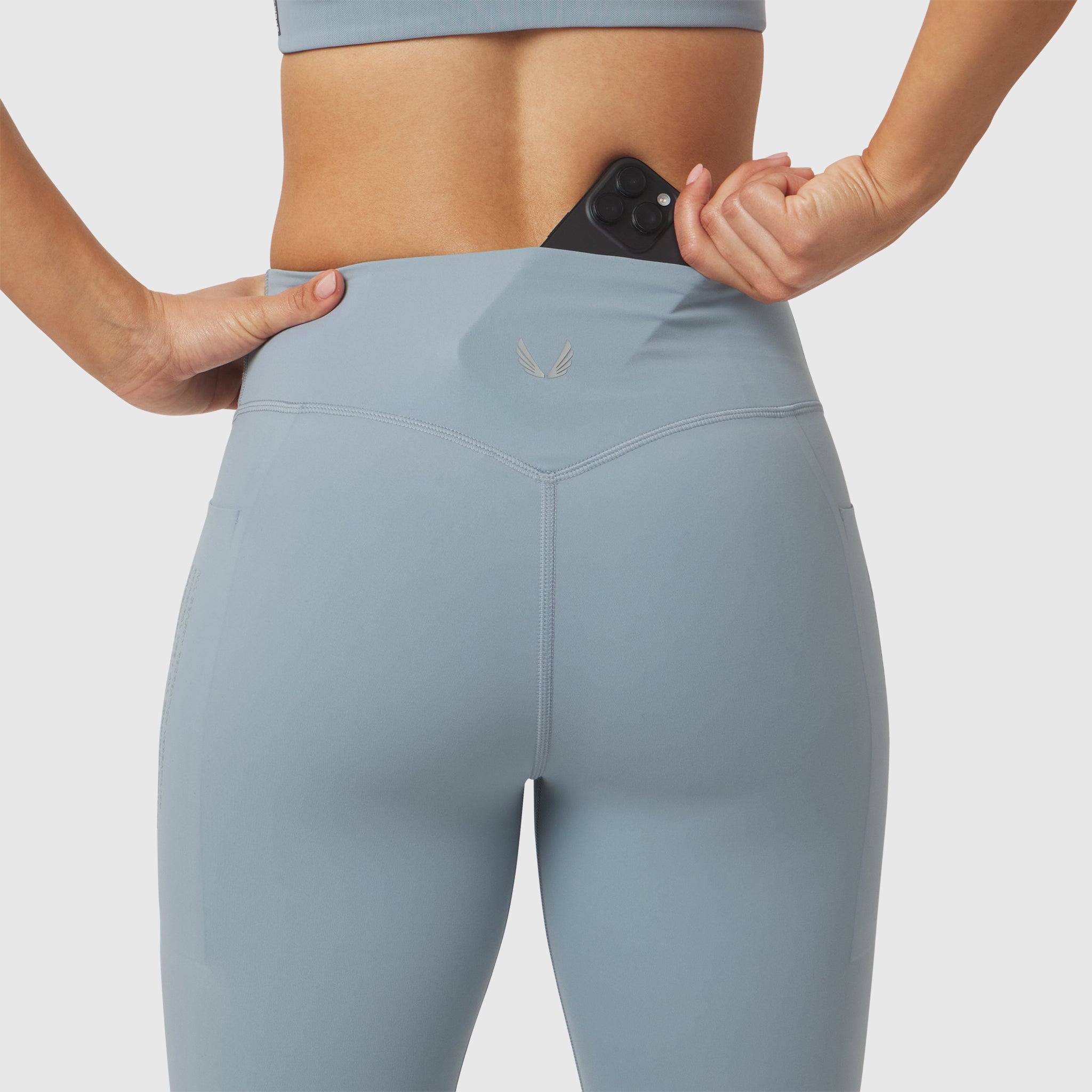 W072 LYCRA® ADAPTIV 4 Pocket Legging in Light Sky, model wearing leggings with phone pocket detail