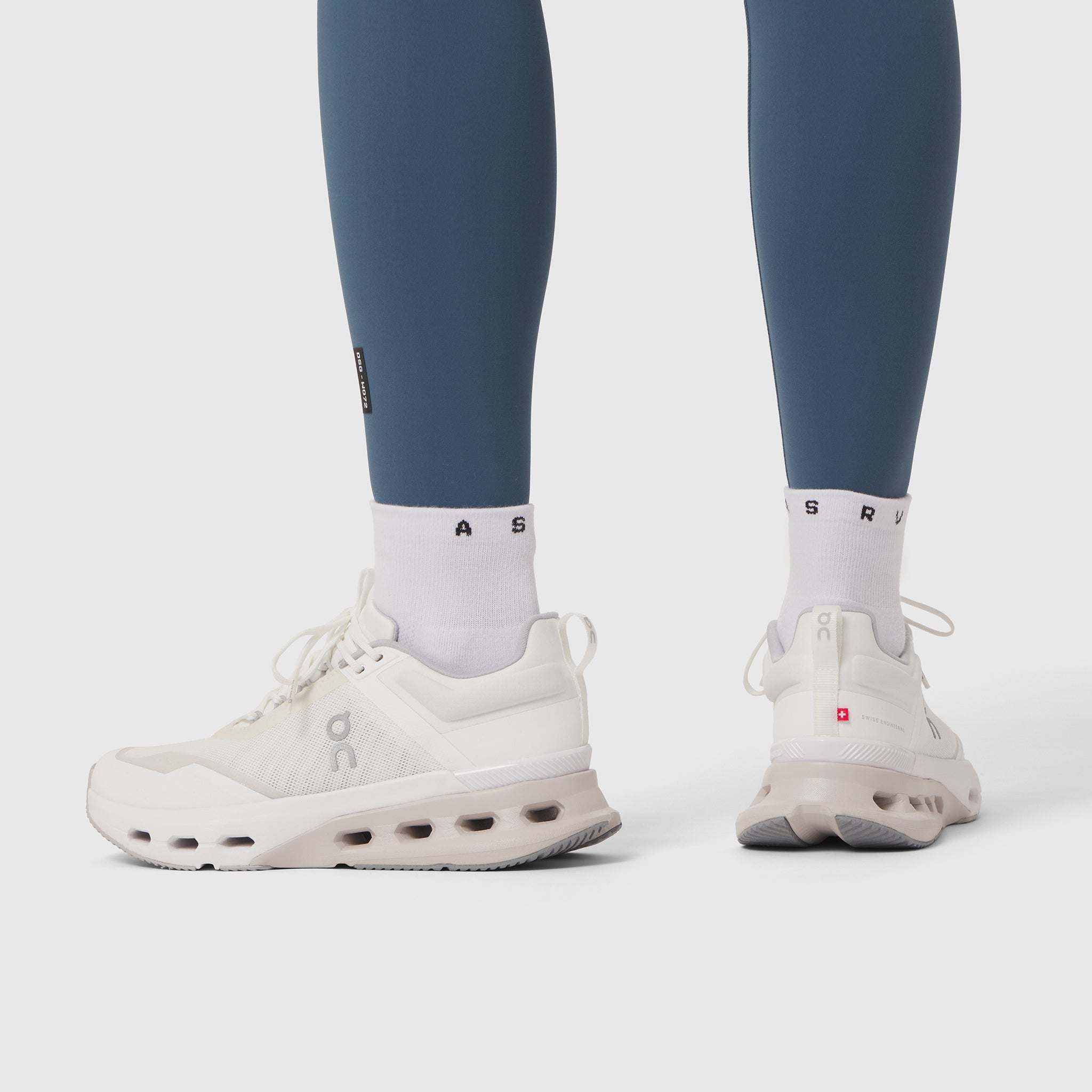 W072 LYCRA® ADAPTIV 4 Pocket Legging in Storm blue worn with white sneakers, front and back view