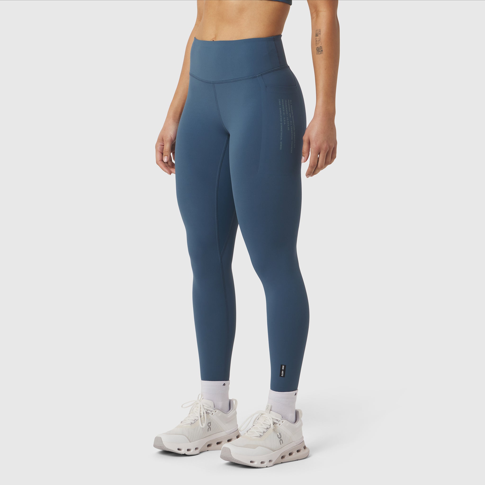 W072 LYCRA® ADAPTIV 4 Pocket Legging in Storm blue, modeled from waist down with white sneakers