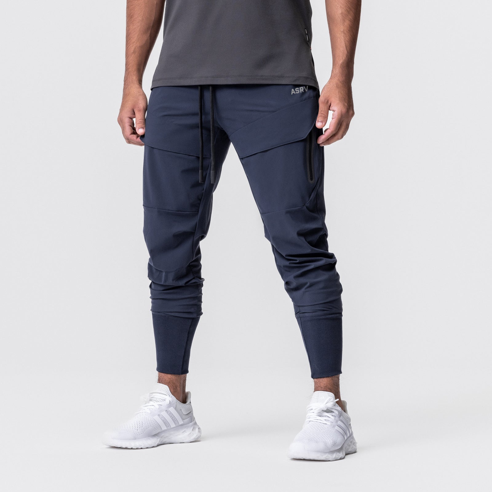 Tetra-Lite® Tech High Rib Jogger in navy, worn by model with white sneakers, front view