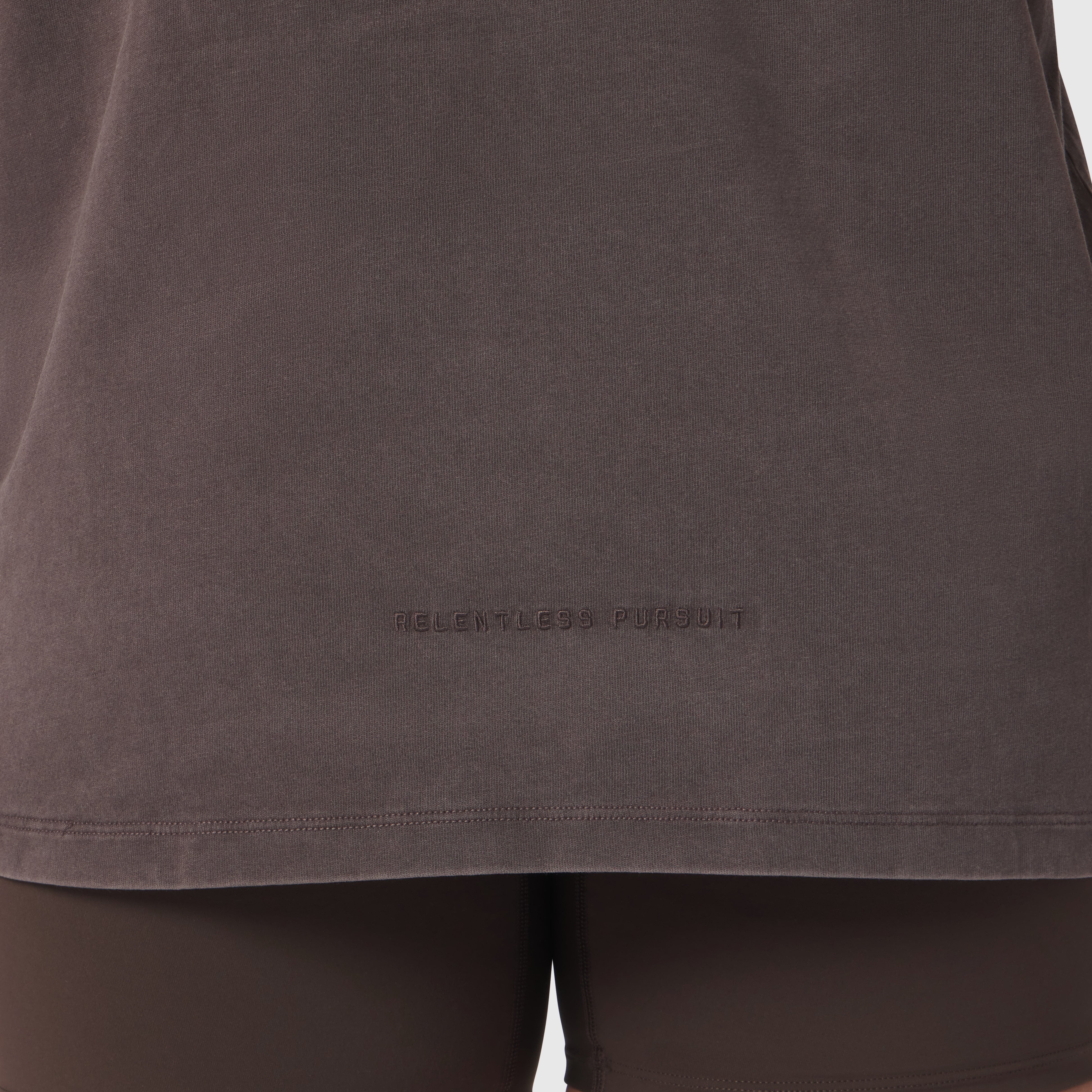 Distressed Relaxed Tee in Dark Earth worn by model, front view showing chest logo
