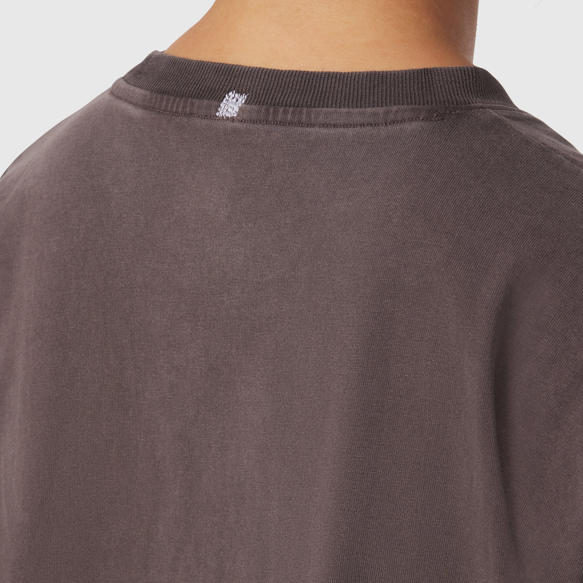 Distressed Relaxed Tee in Dark Earth, back neckline detail on model