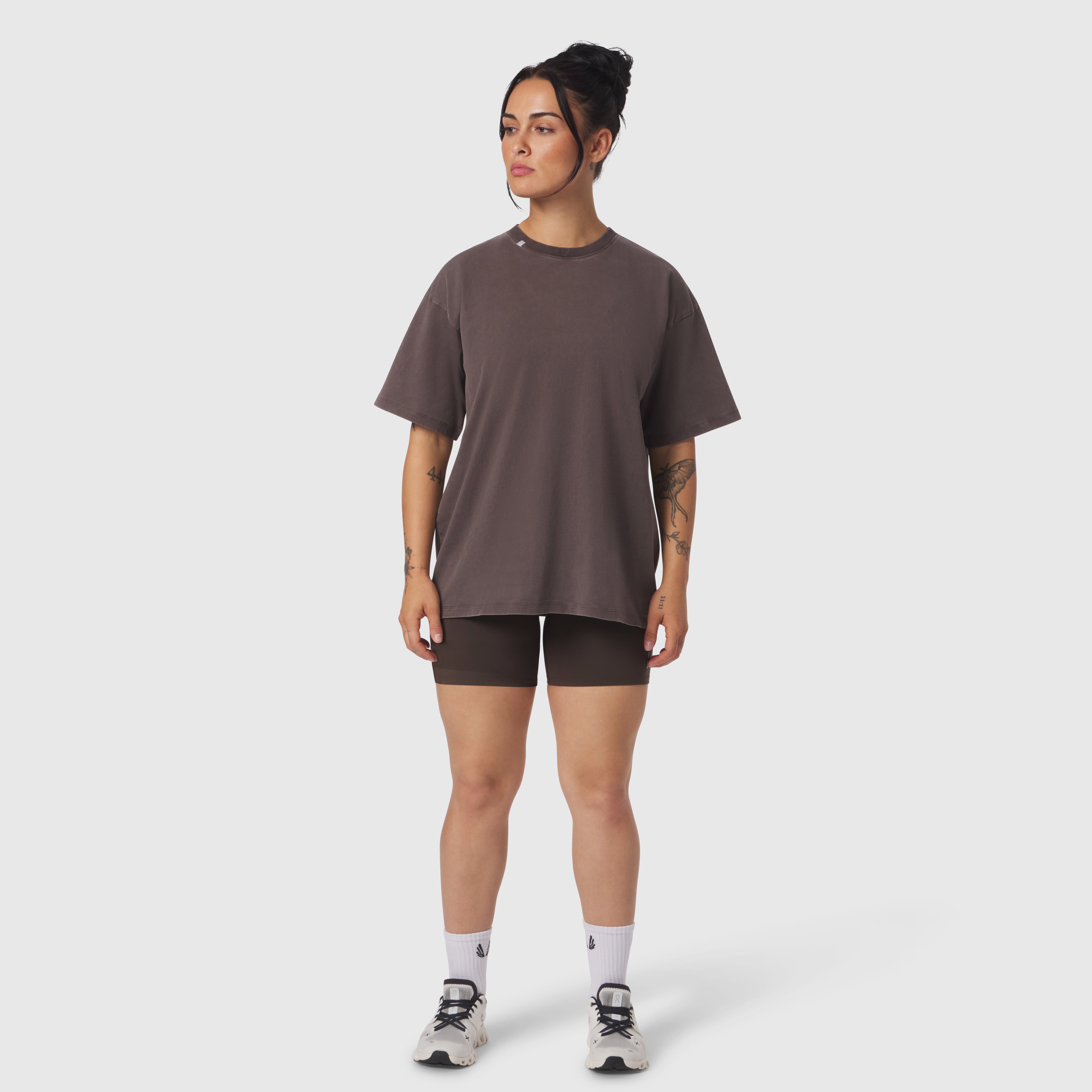 Distressed Relaxed Tee in dark earth worn with black shorts and white socks, front view on model