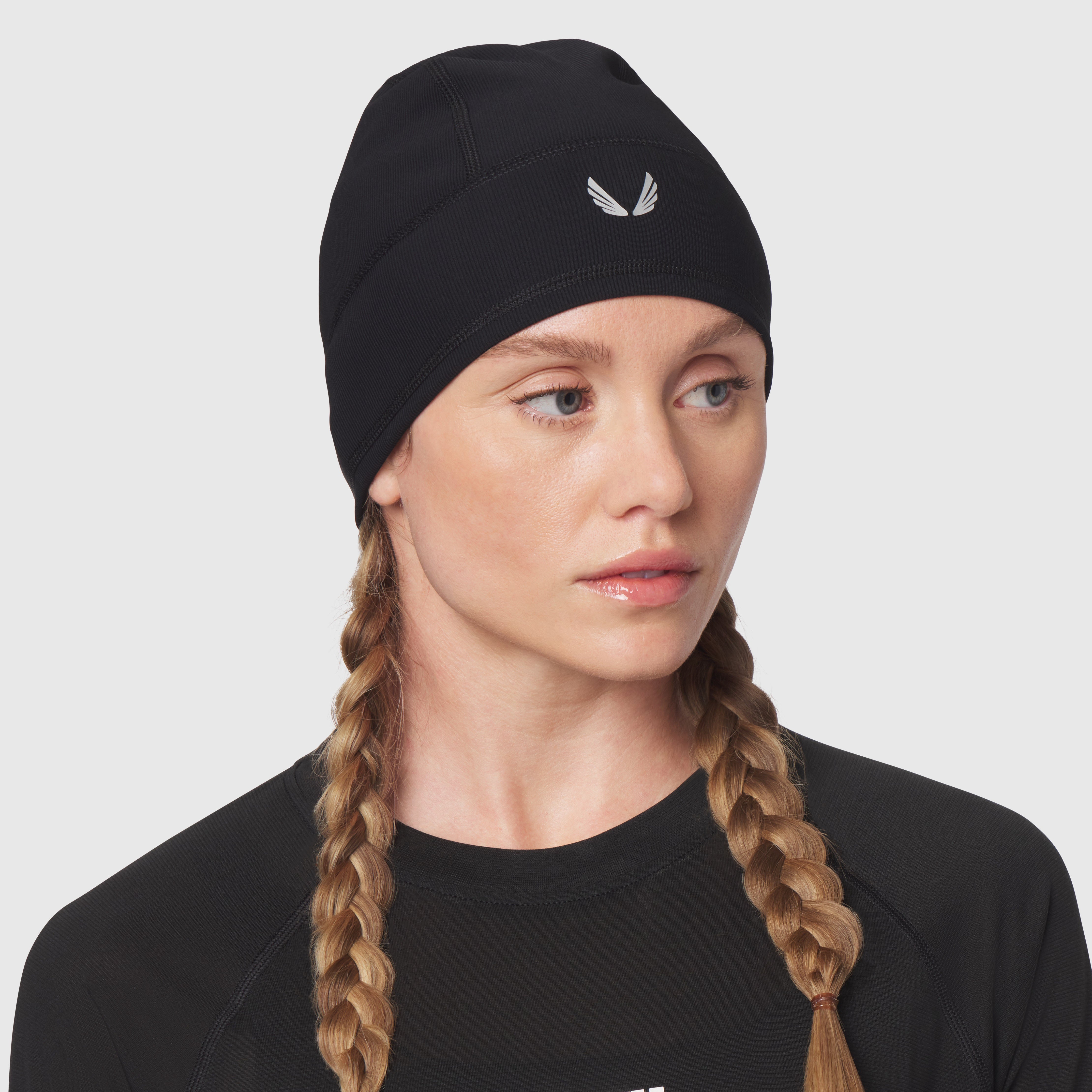 Black Lycra® Skully beanie worn by model with braided hair, front view