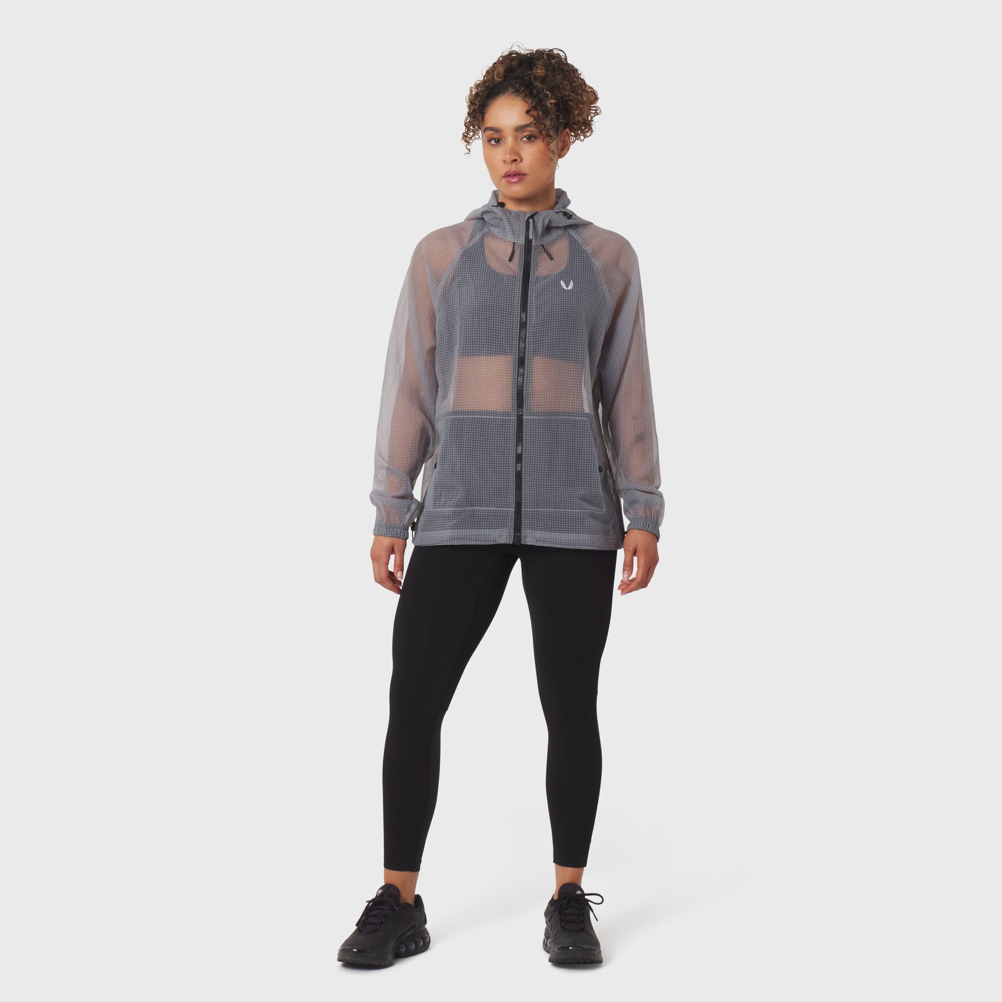 Weather-Ready Transparent Ripstop Shell Jacket in slate grey, worn with black leggings, front view