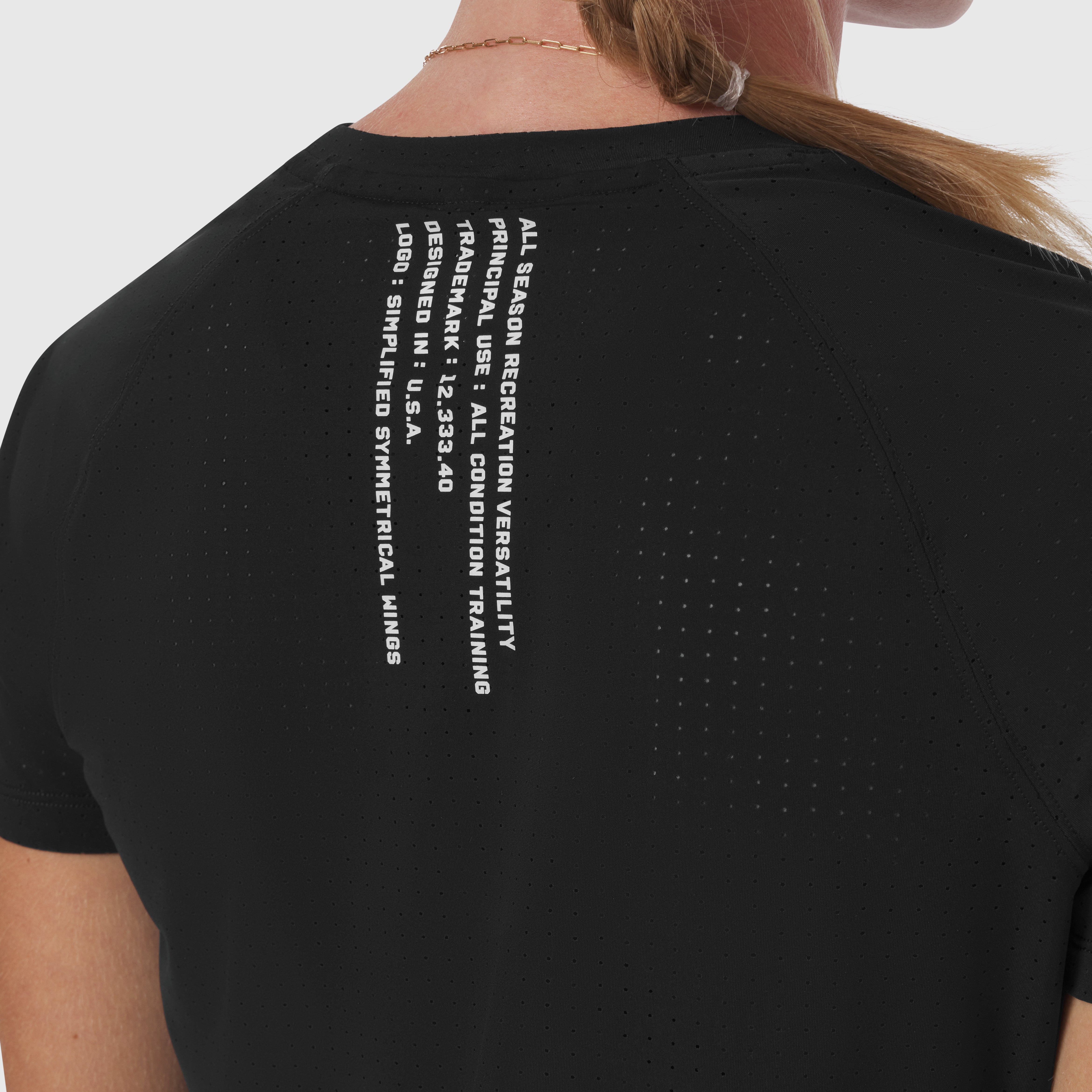Black Laser-Vent Established Tee worn by model, back view showing white text graphic