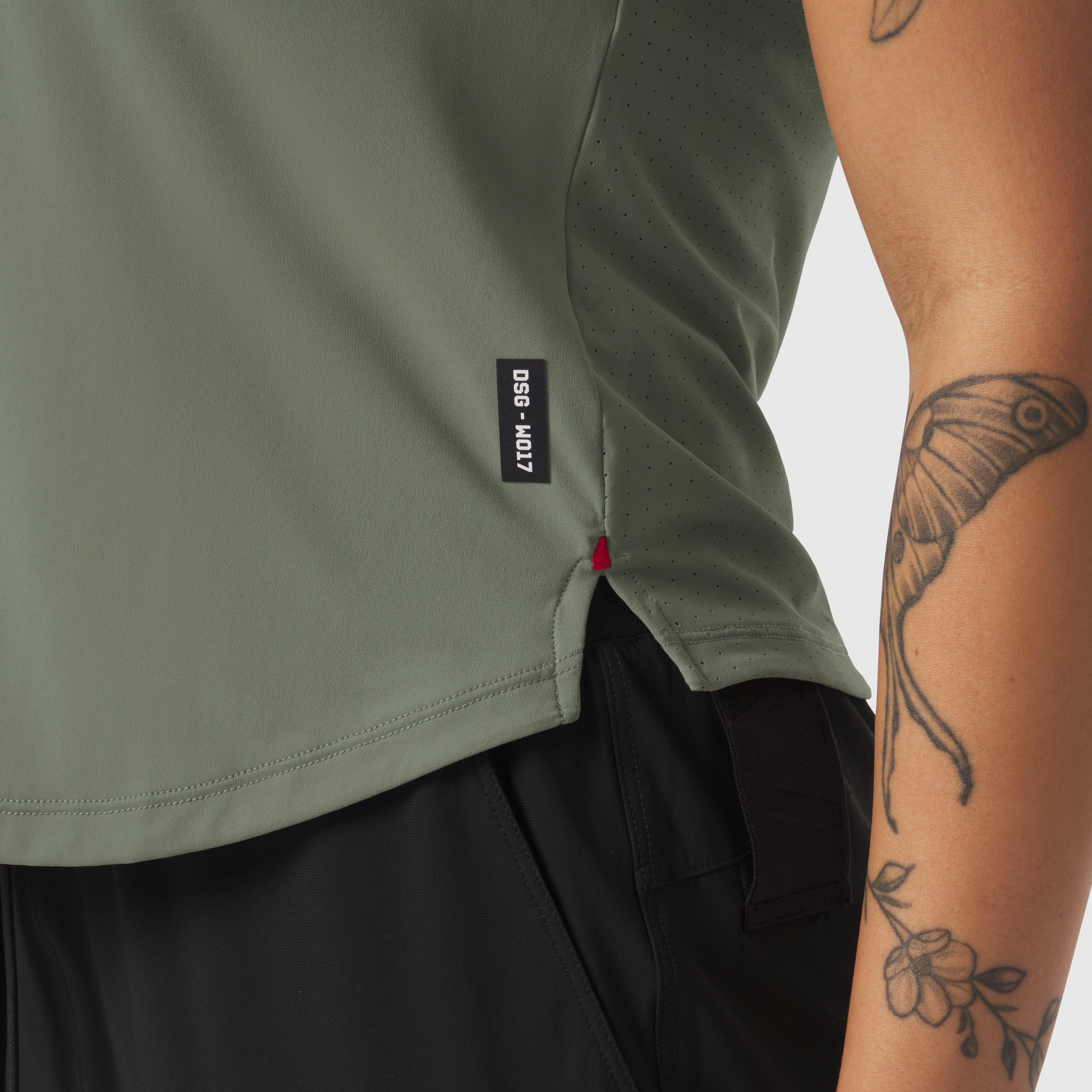 Laser-Vent Established Tee in sage worn by model, side detail view showing ventilation holes